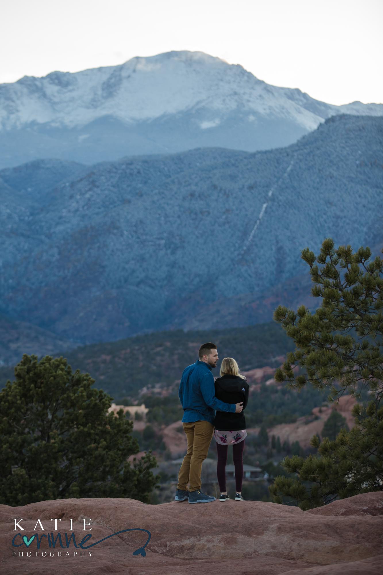 couple looks out to mountains at Garden of the Gods