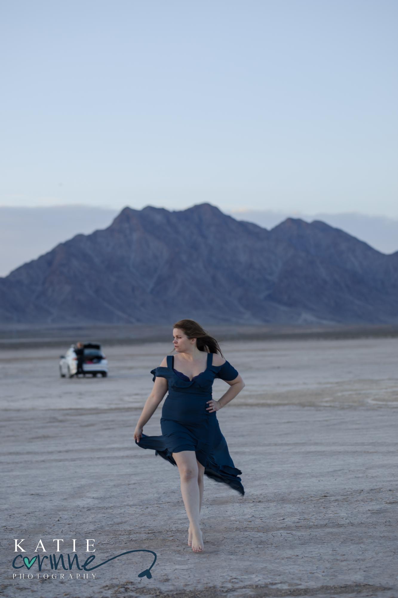 Woman in blue dress in front of mountains