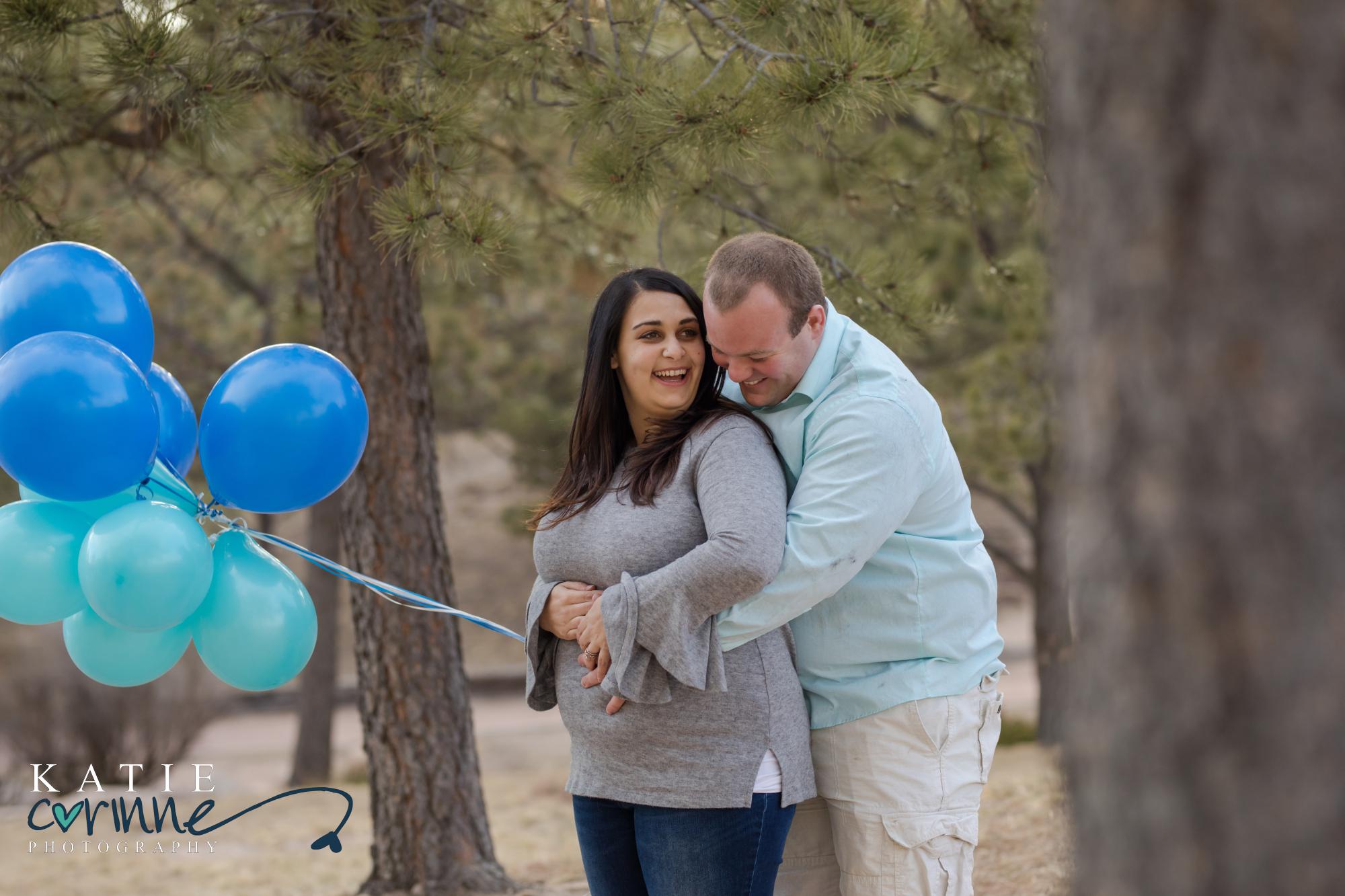 Colorado pregnant couple hold blue balloons at gender reveal