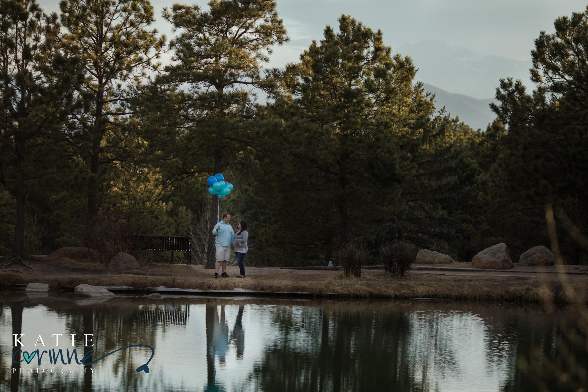 Colorado Springs couple stands across lake at gender reveal session