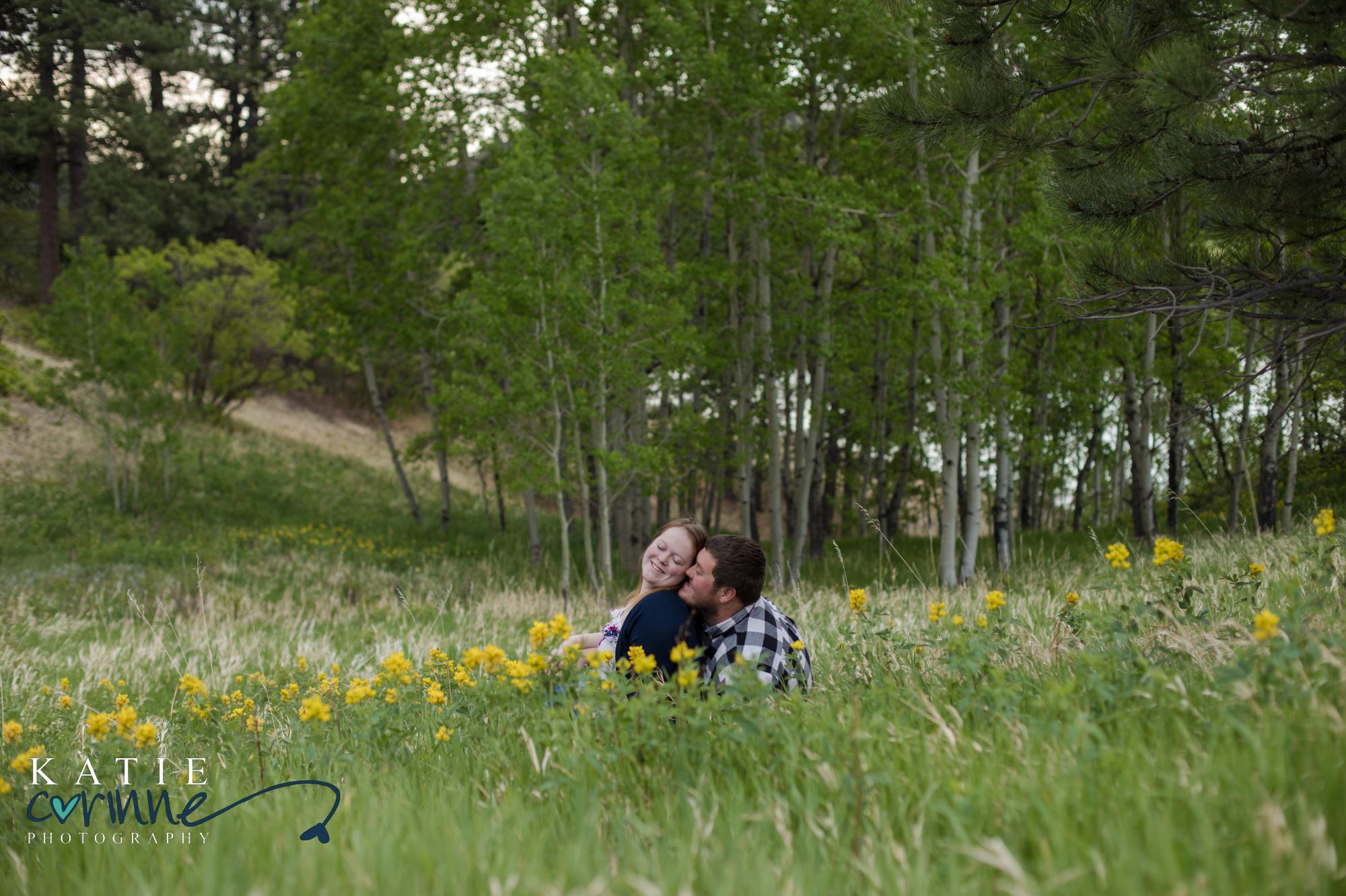 couple cuddle during Colorado Springs engagement session