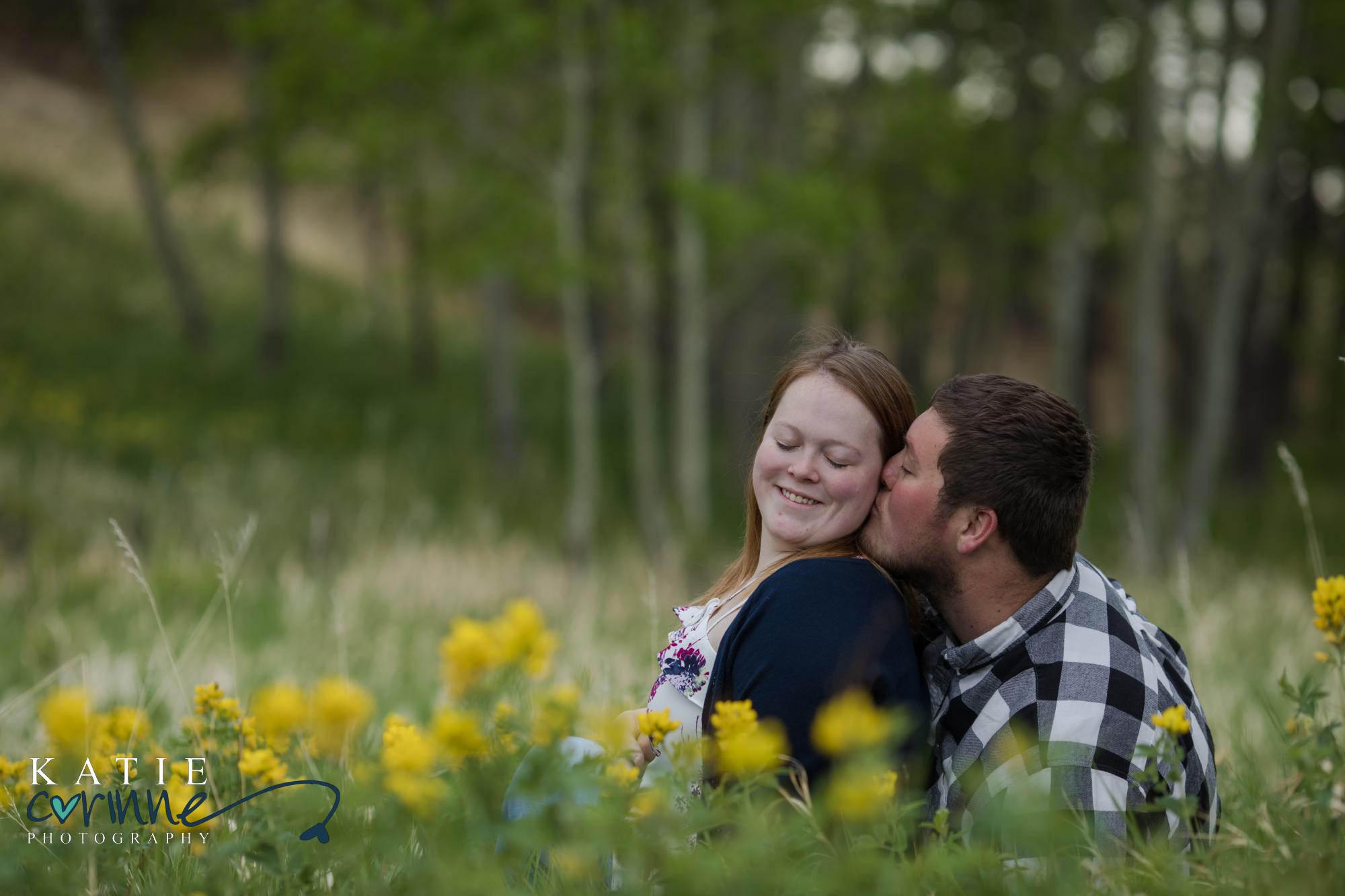 Colorado Springs couple kiss in wildflower field