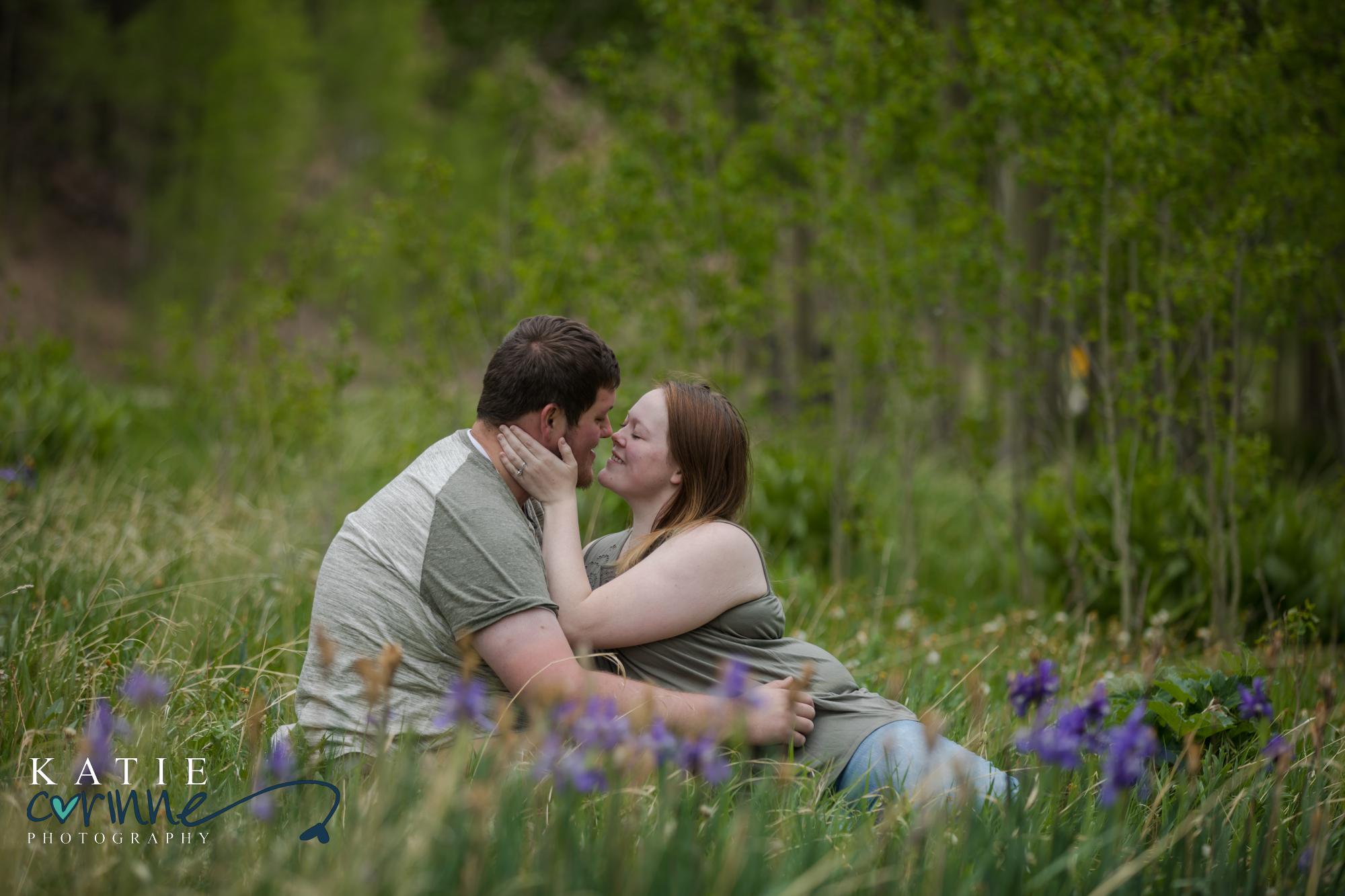 engaged couple cuddle in San Isabel National Forest