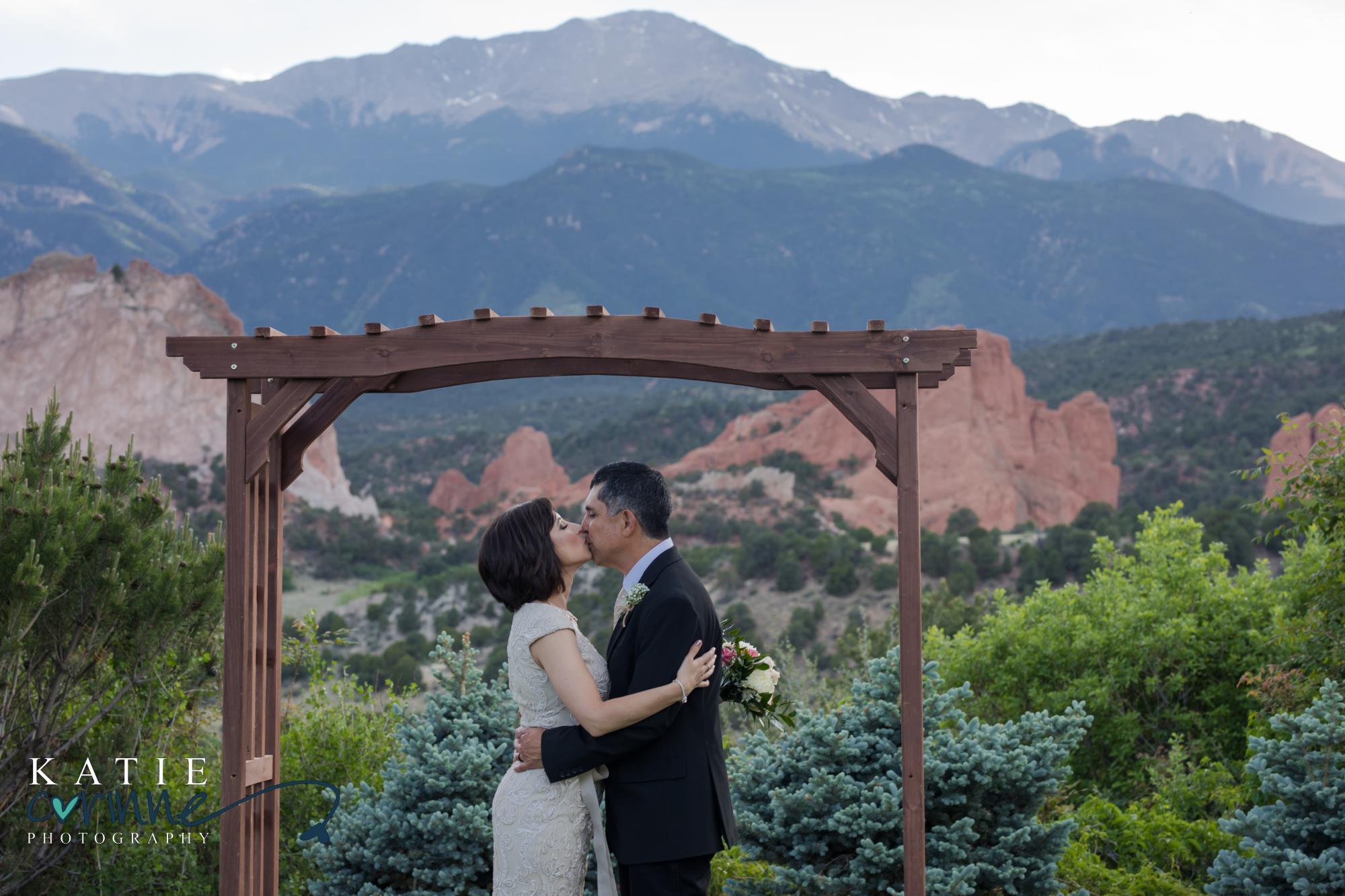 bride and groom in front of rocky mountains