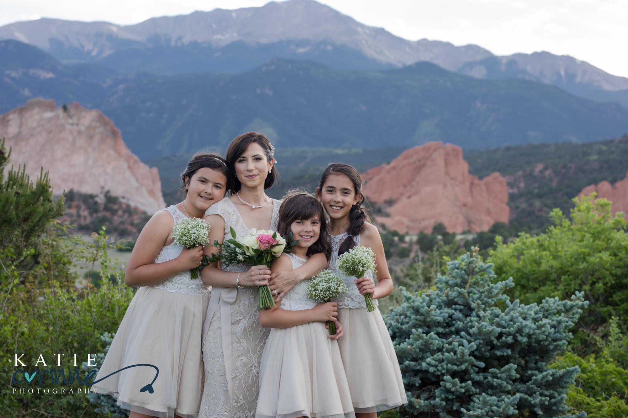 bridal party in front of mountains and red rocks