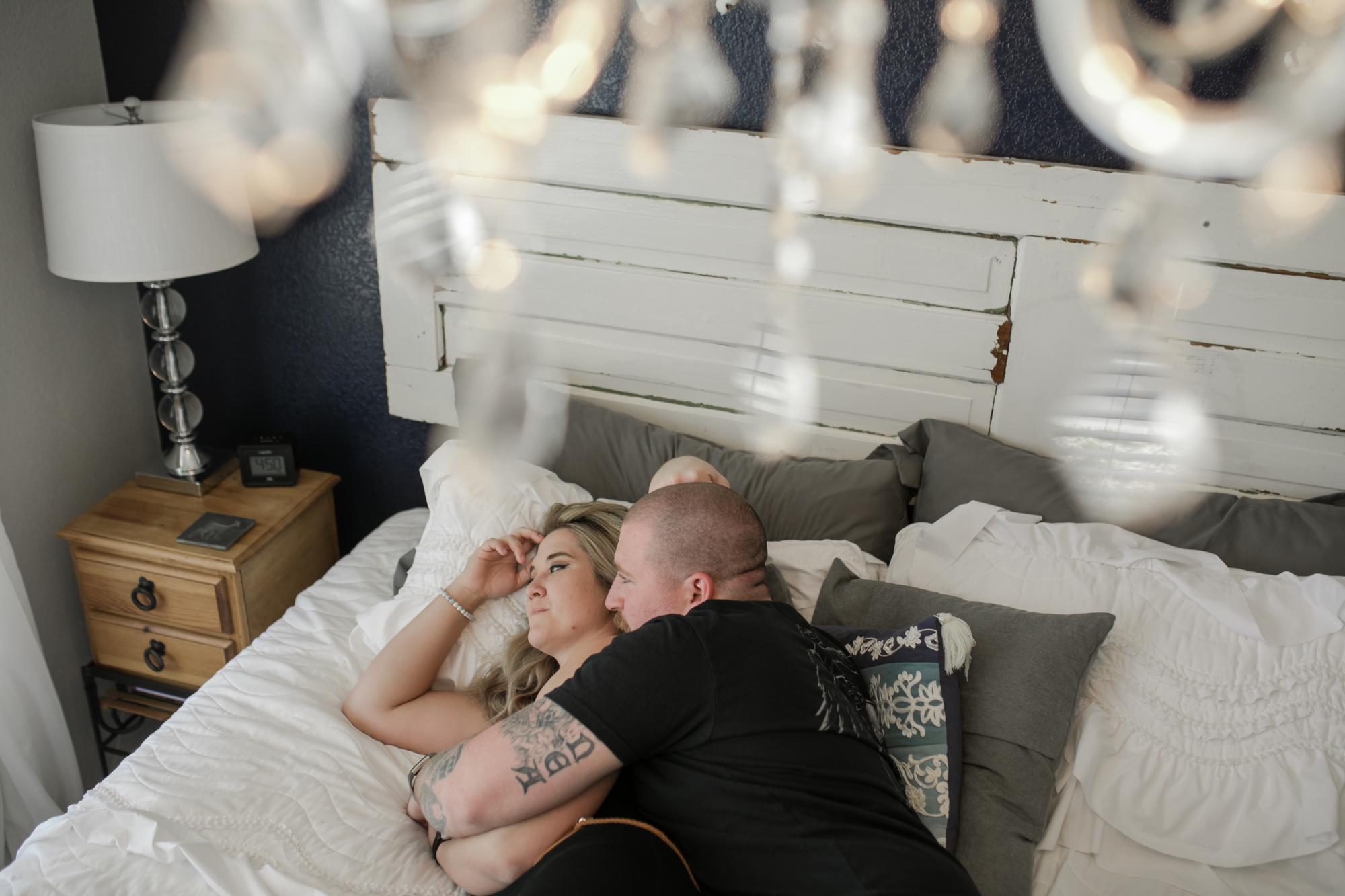 Colorado Springs couple cuddles during in home photo session