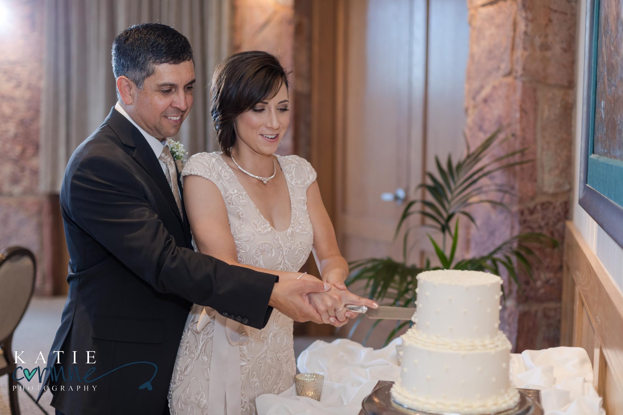 bride and groom cut cake at destination mountain elopement