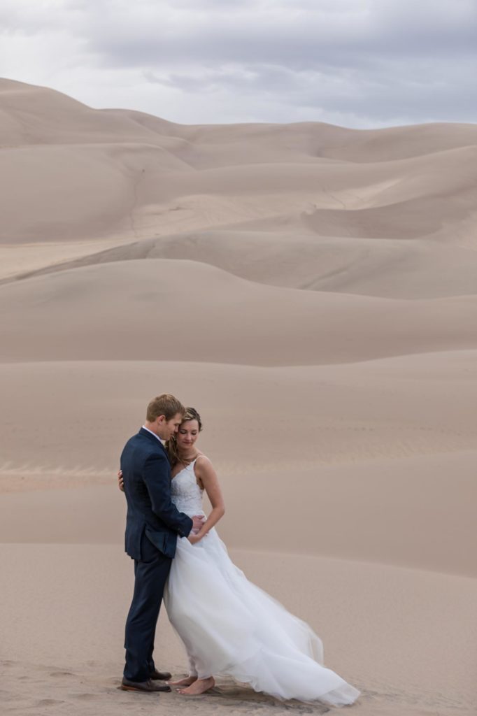 bride and groom in front of mountains on day after wedding