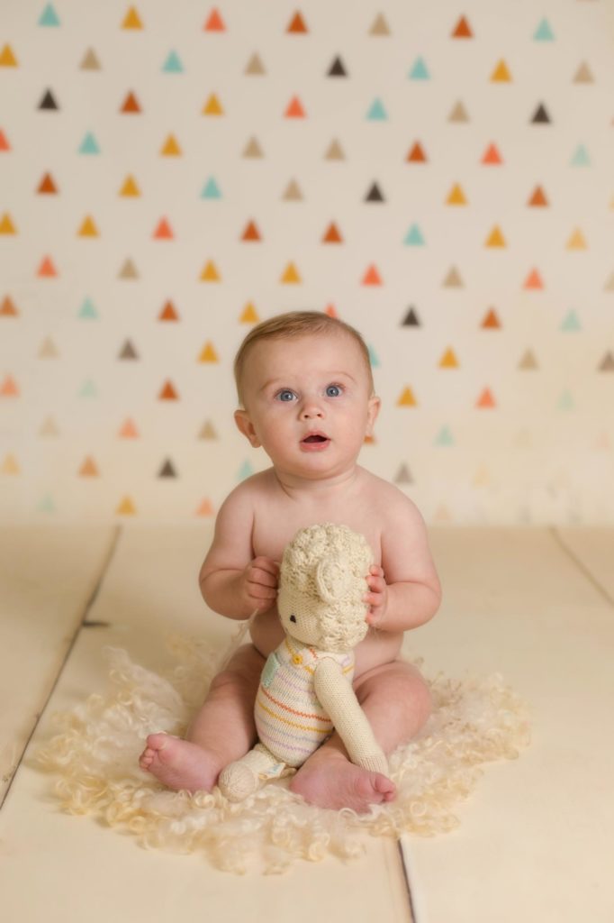 six month old poses for Colorado baby photographer