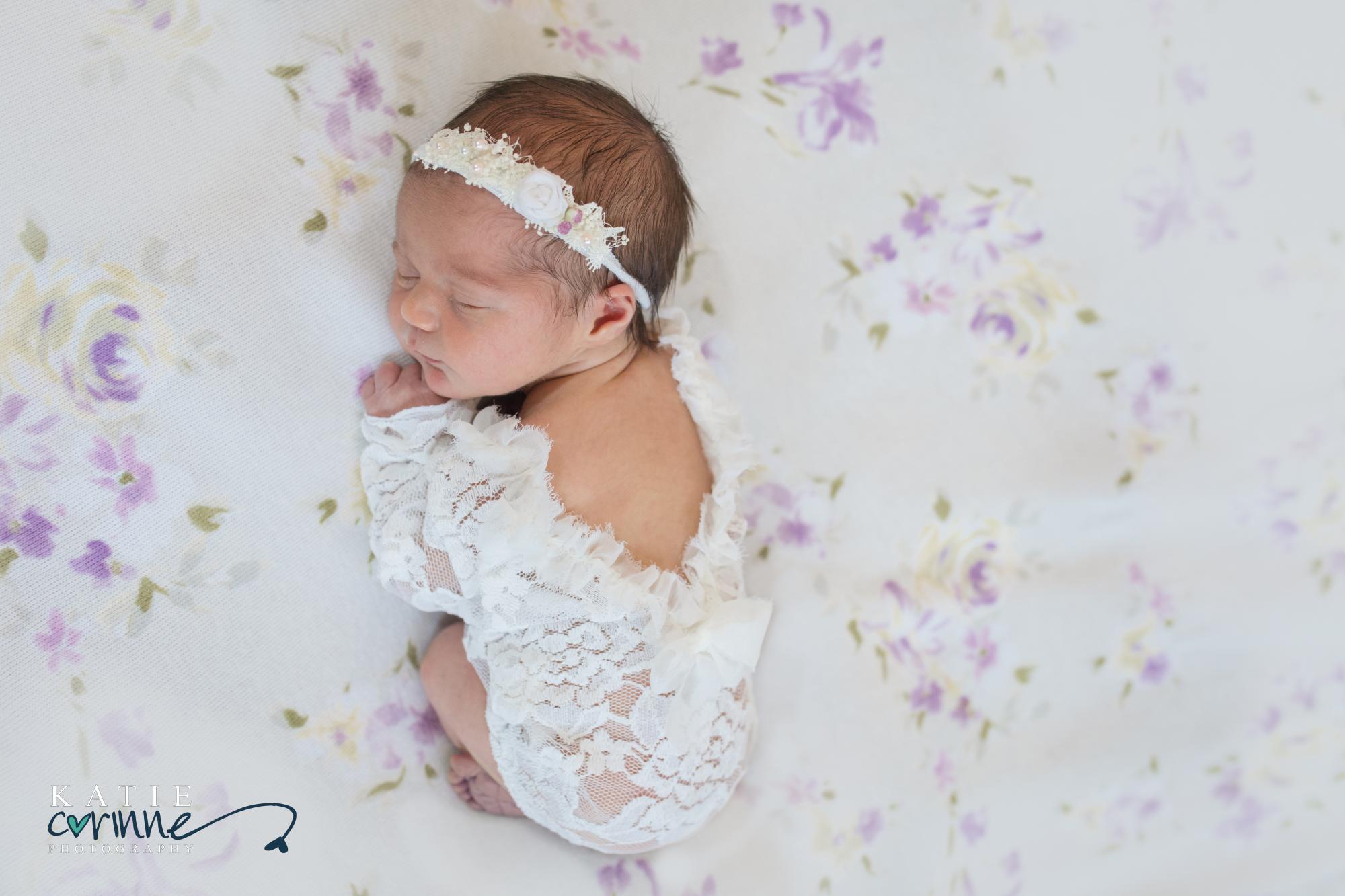 Sweet newborn girl with flowers