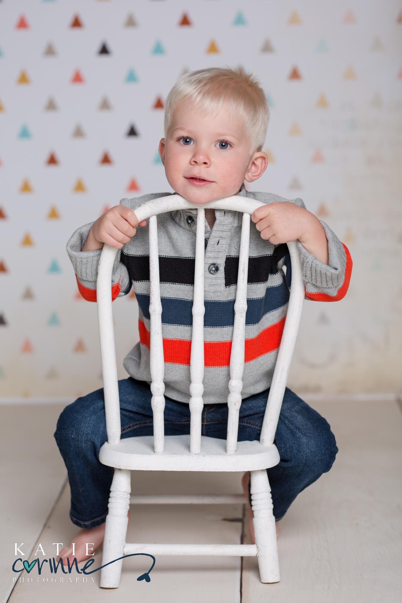 little boy sitting on chair