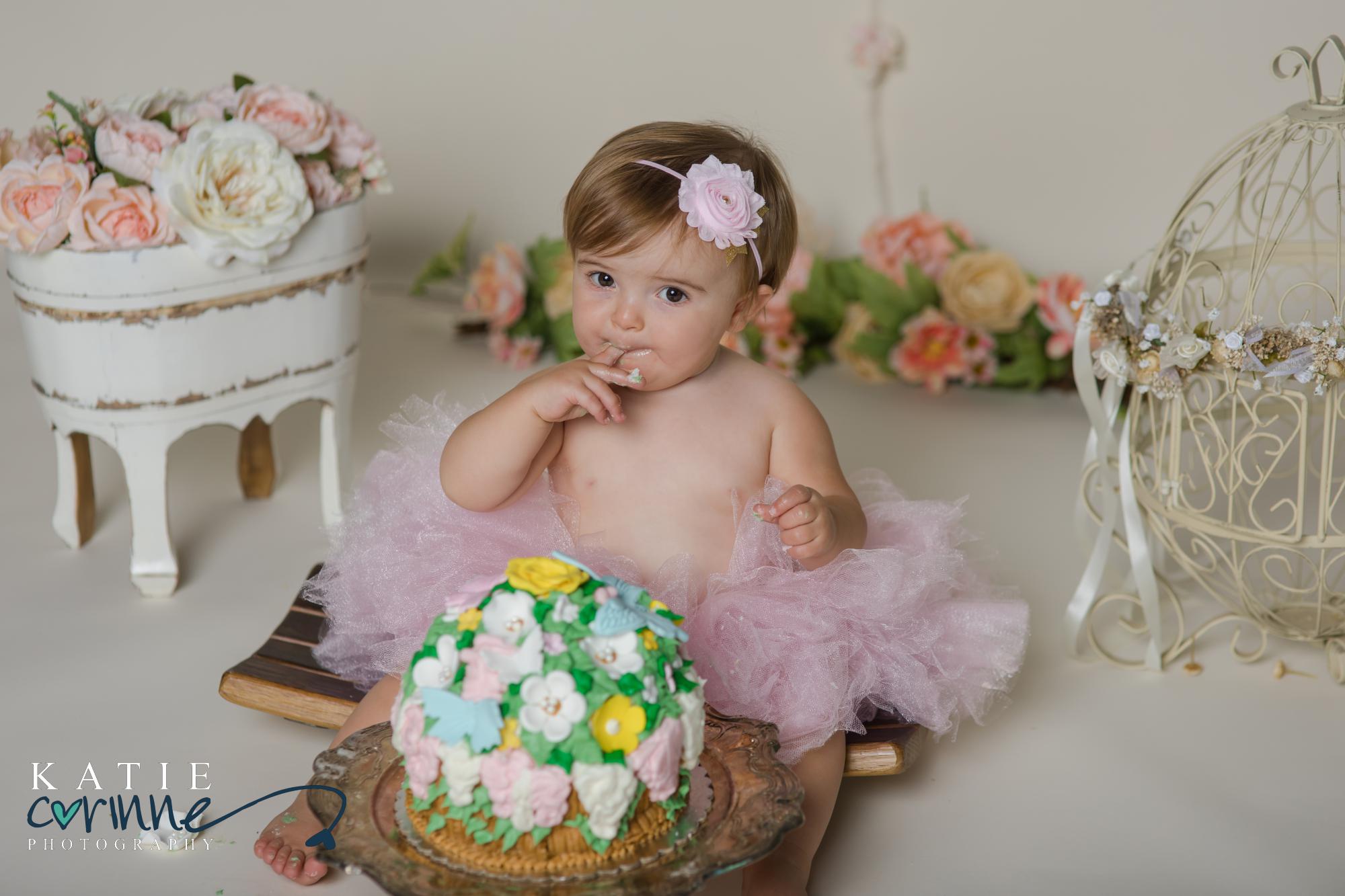 Baby tasting cake at cake smash session