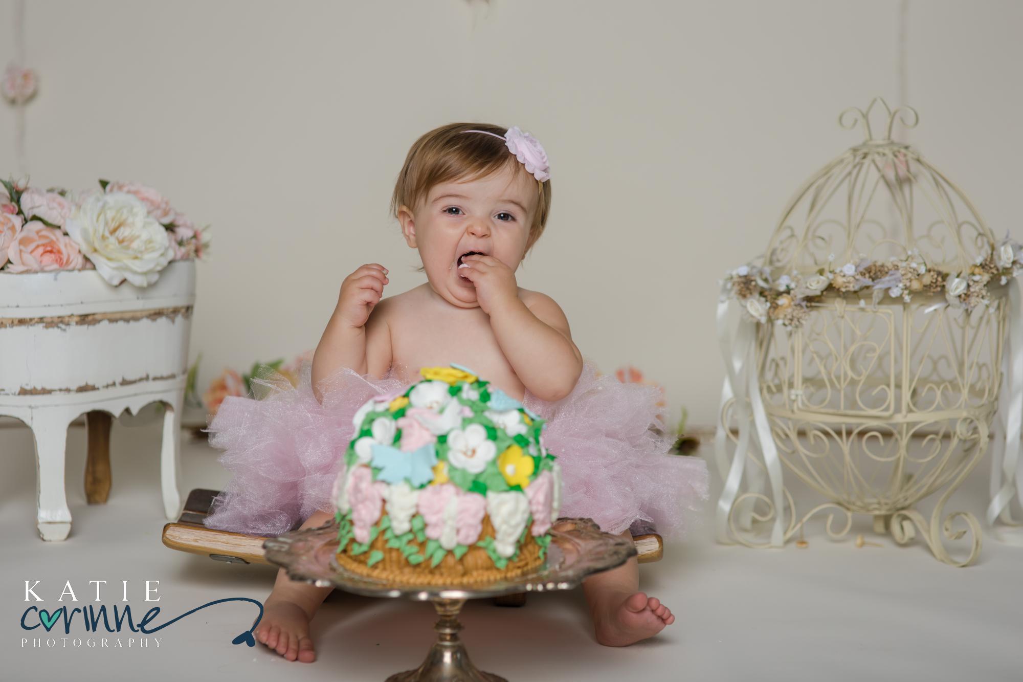baby tasting her smash cake