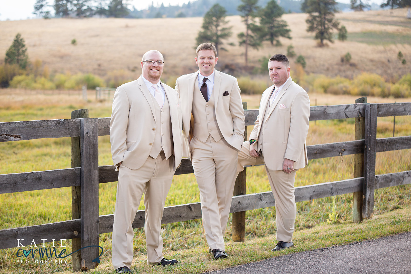 Groomsmen posed on fence at Colorado Ranch Wedding
