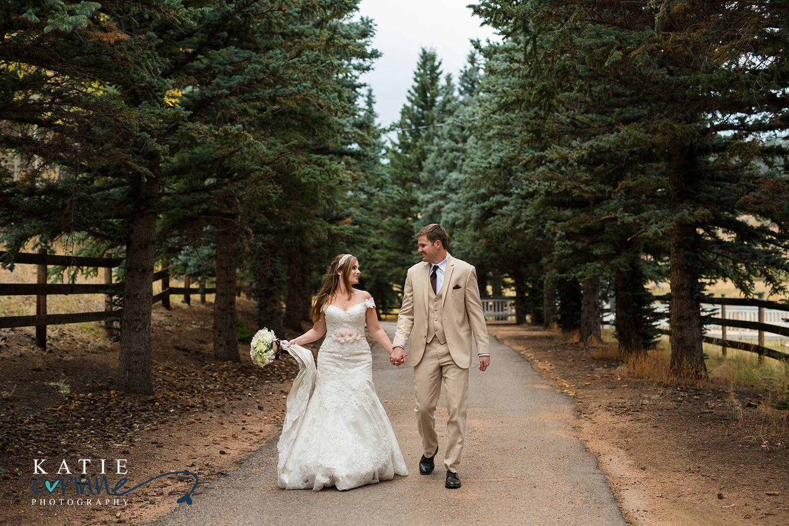 Bride and Groom walking through Colorado Forest