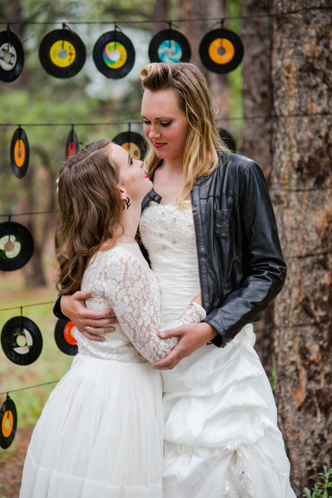 Bride and Bride in leather jacket and wedding dress