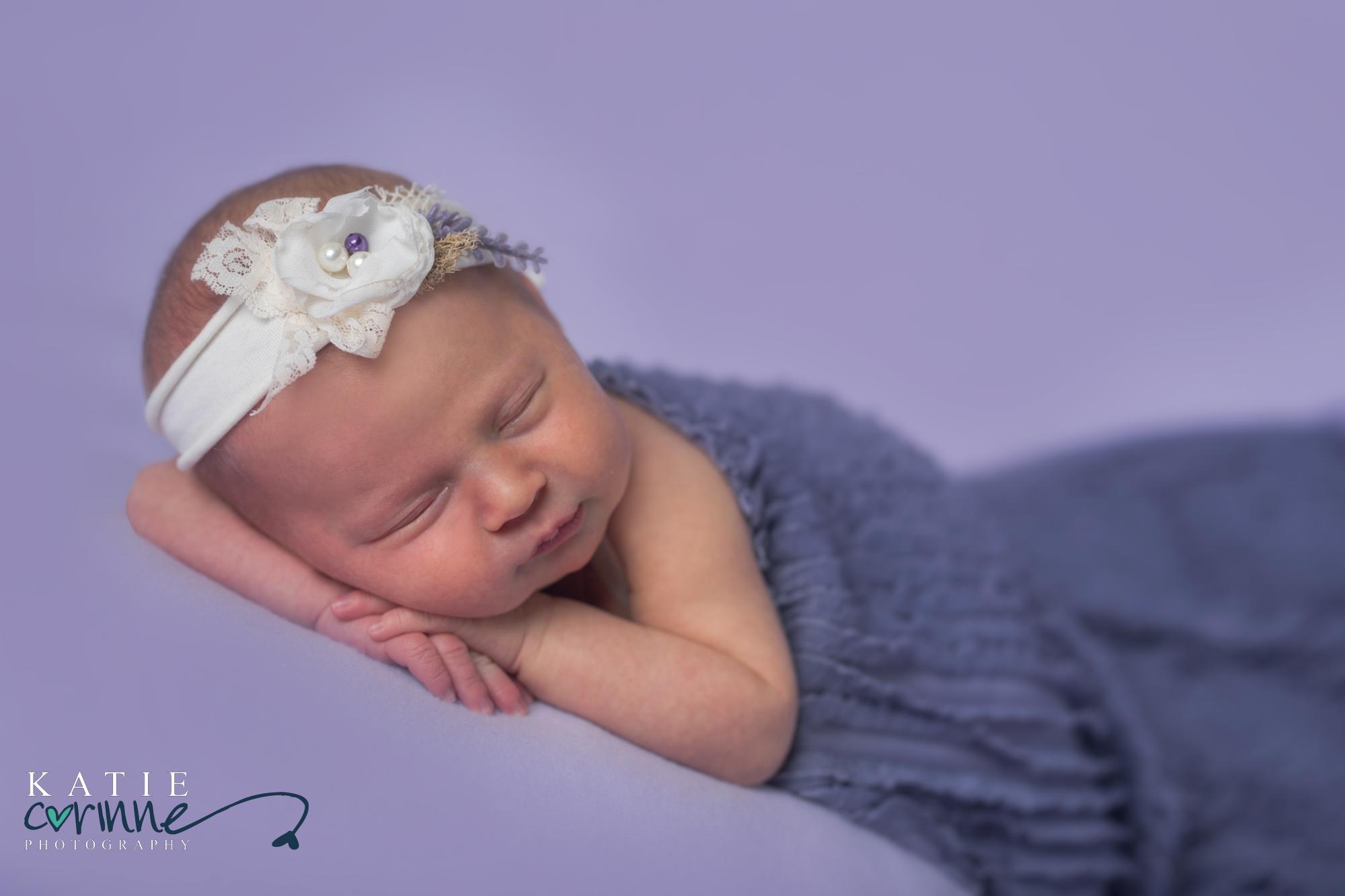 Newborn baby girl with white and purble floral headband