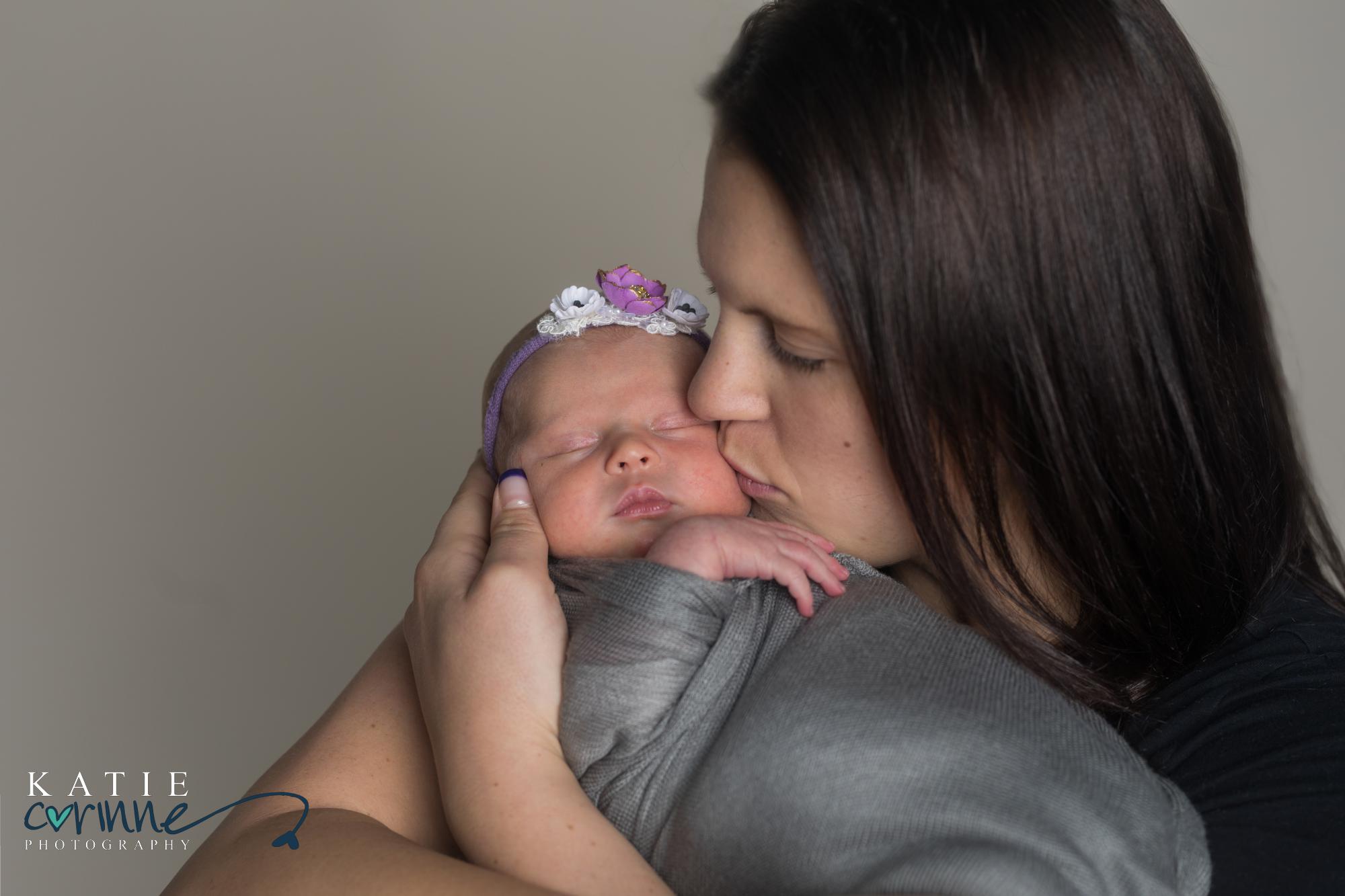Colorado mother kisses baby daughter for photo