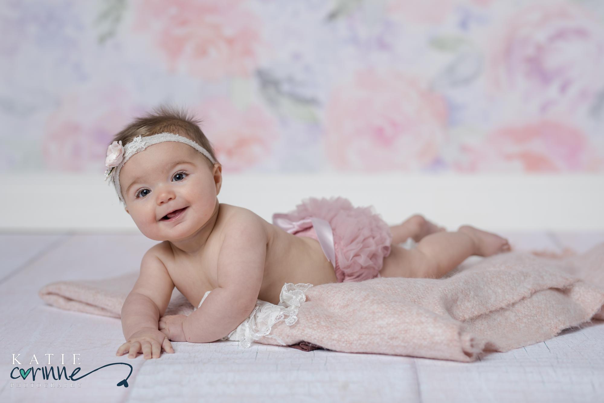 6 month Baby against floral backdrop