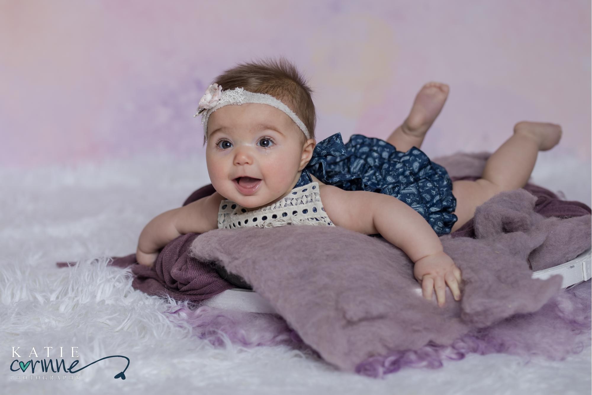 baby girl gets photos taken to celebrate turning 6 months old