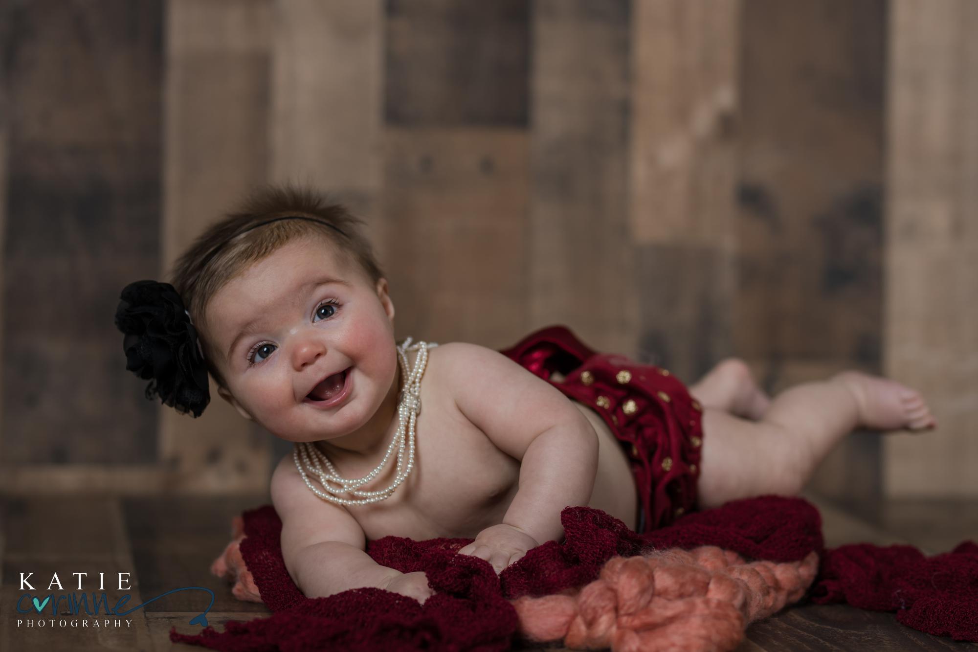 Colorado baby wears pearls ans smiles