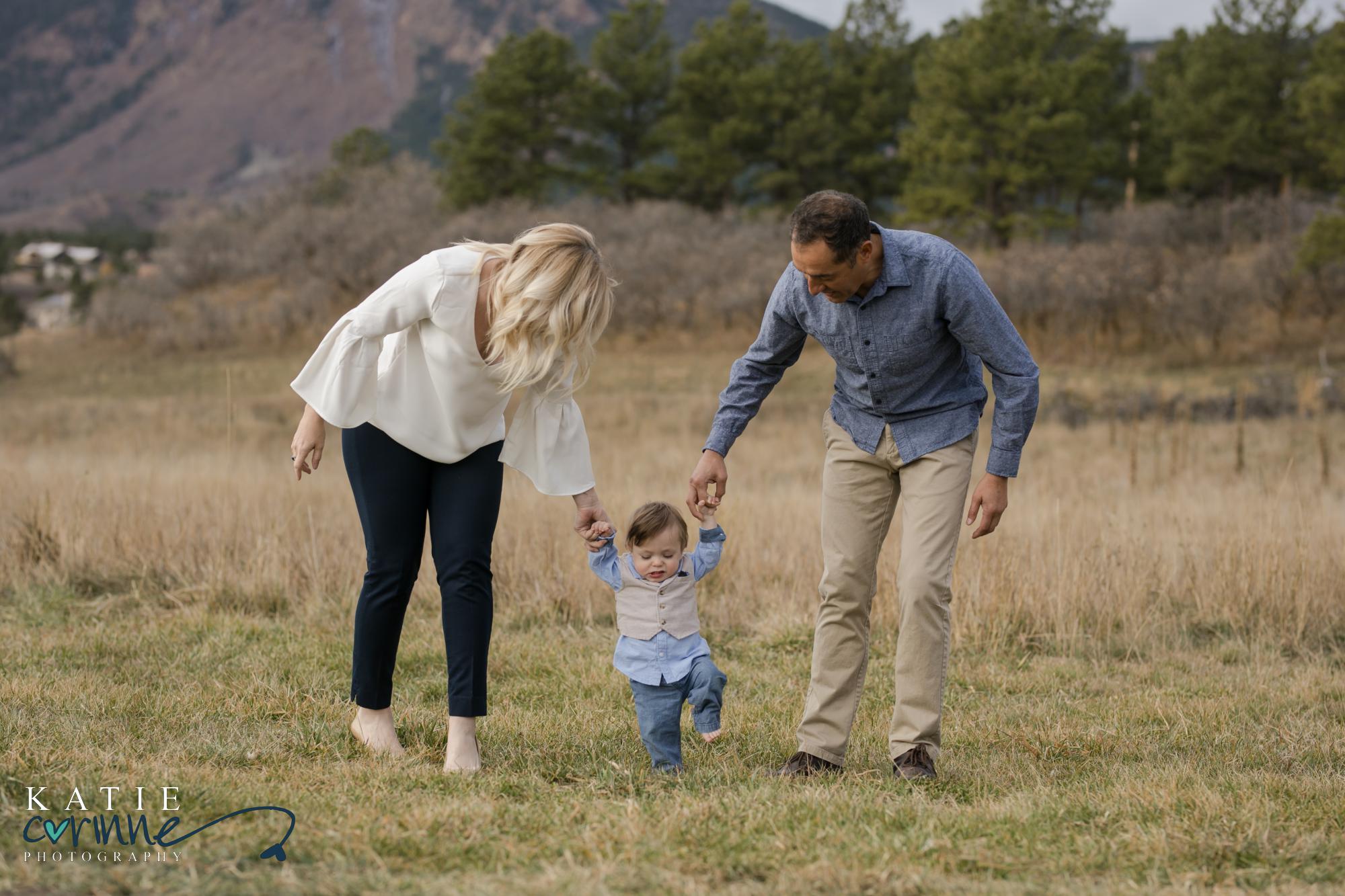 Monument Colorado family walks toward camera holding hands