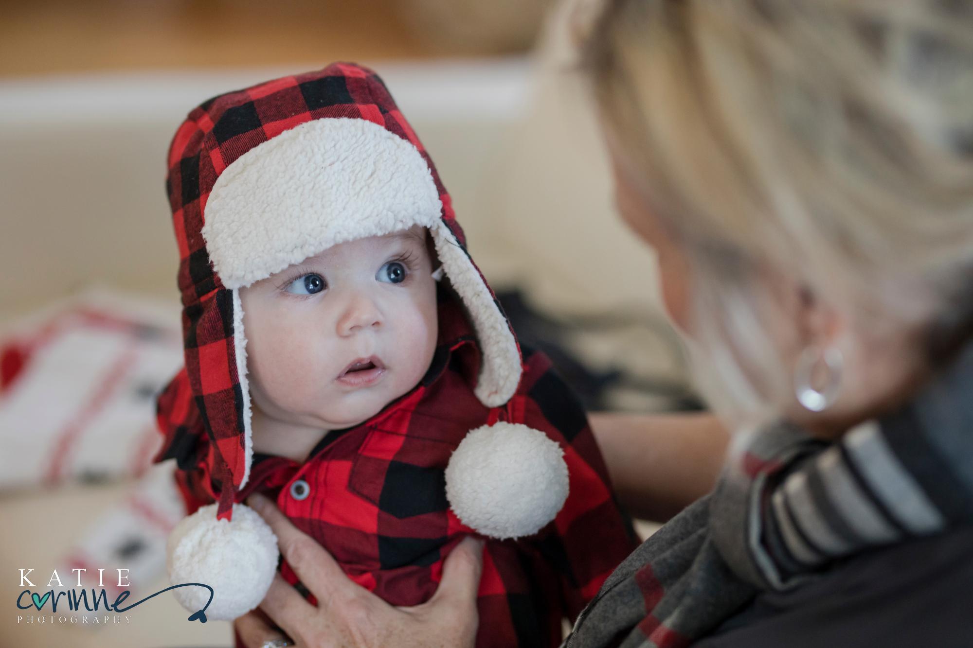 Colorado Baby dressed in plaid looks up at woman