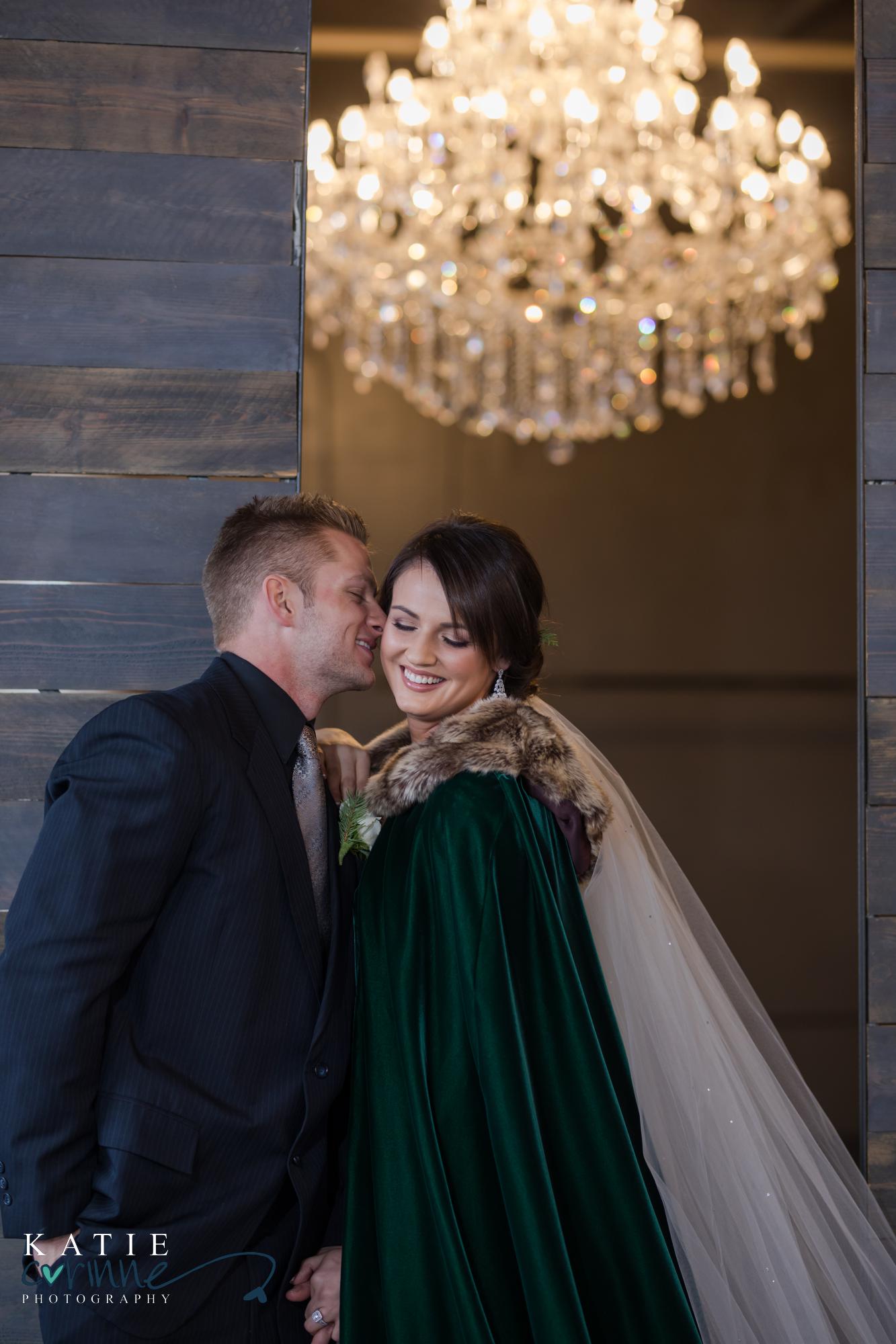Colorado Winter Wedding couple pose playfully with bride wearing green fur cape