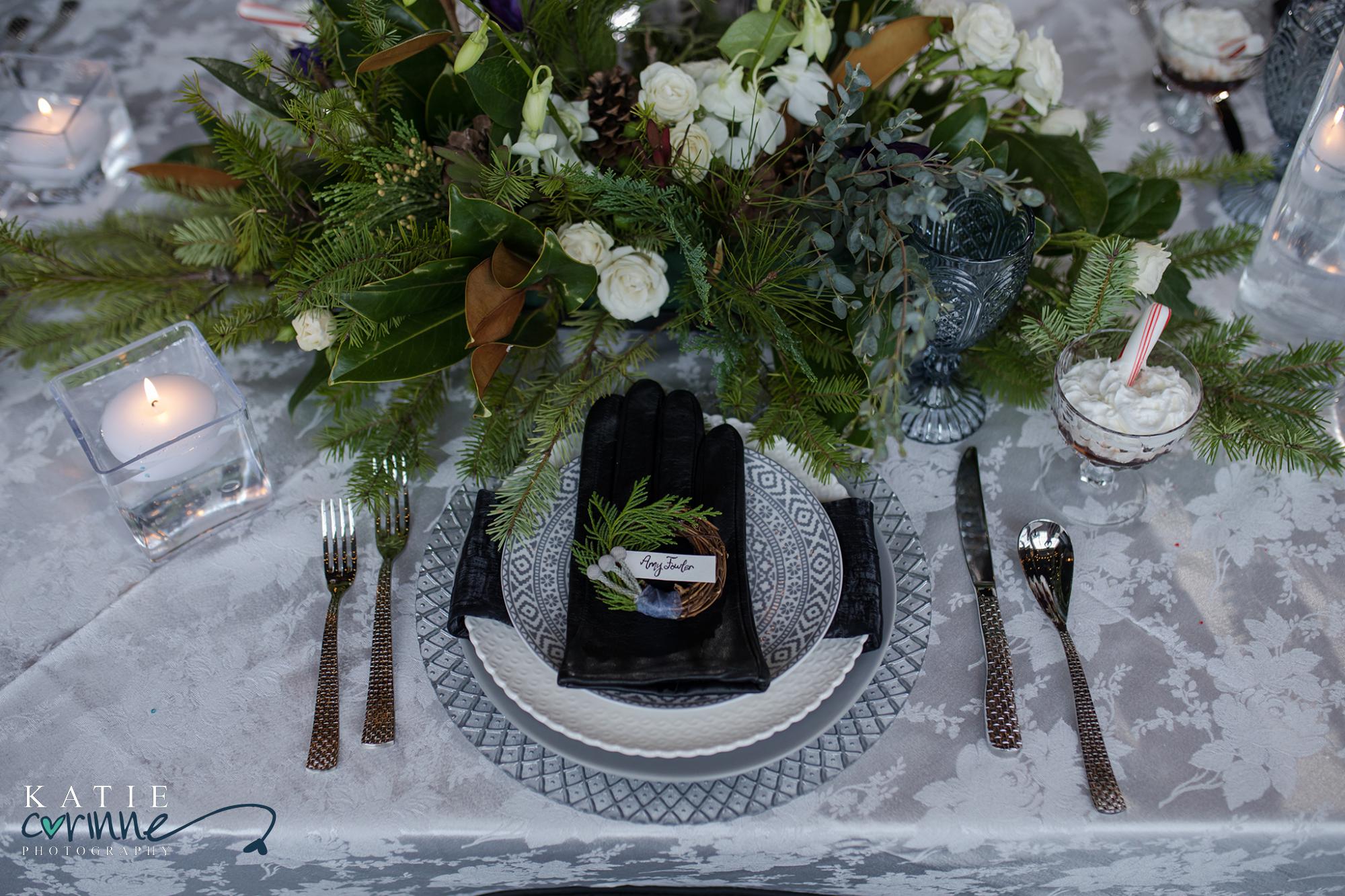 place setting at wedding with gloves on top of plates as party favors