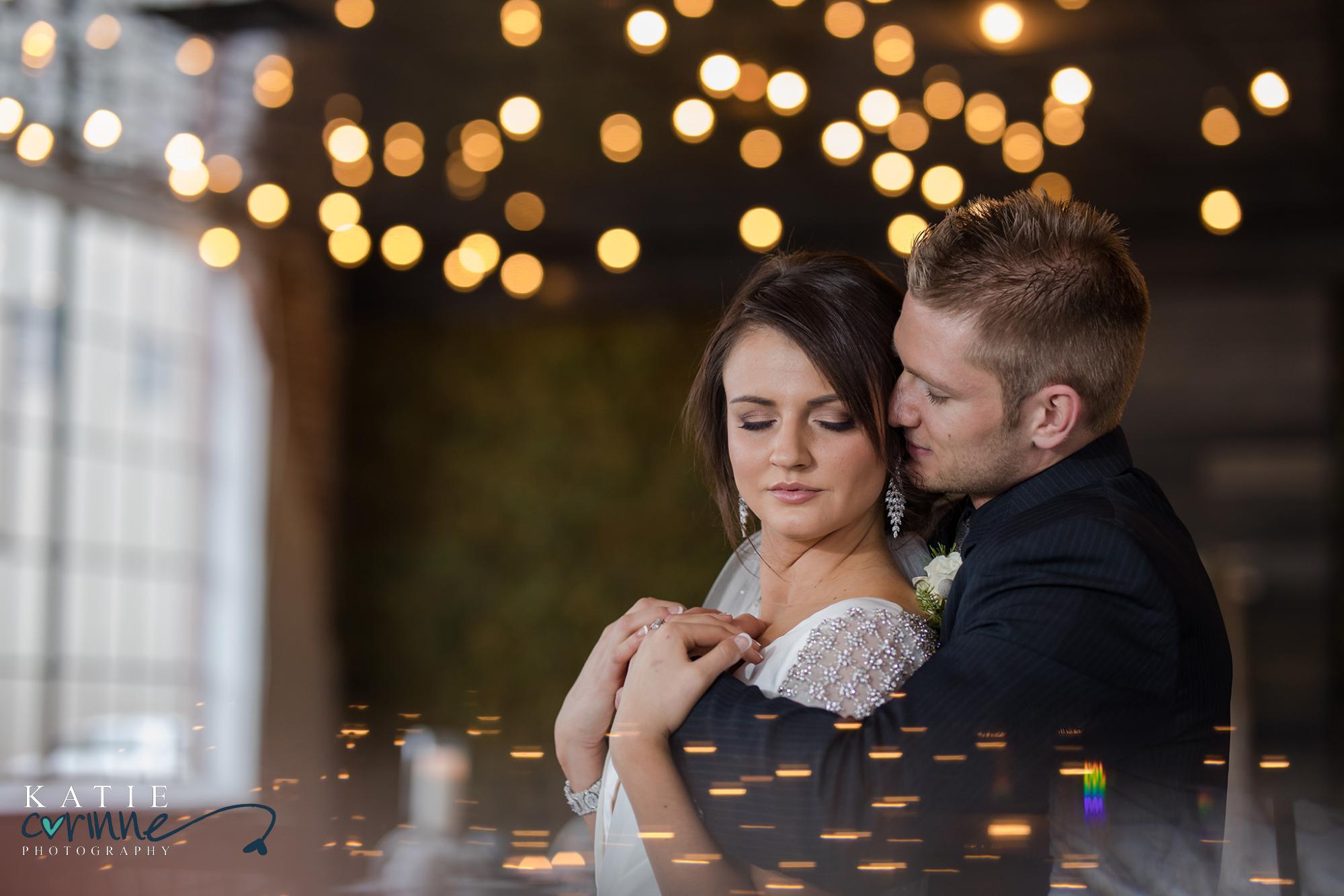Denver Winter Wedding couple hold each other surrounded by Christmas lights