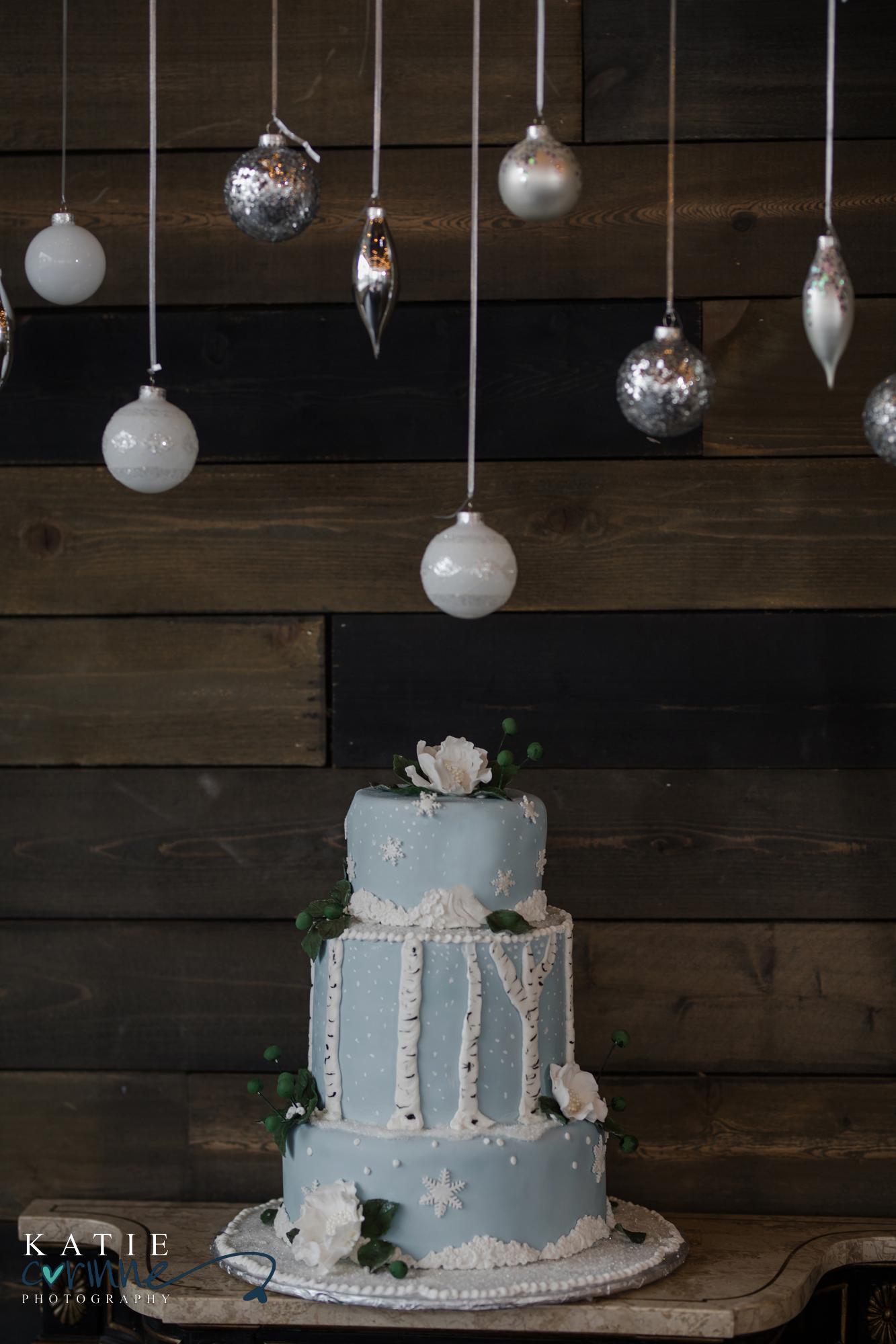 Colorado Winter Wedding Cake under hanging ornaments