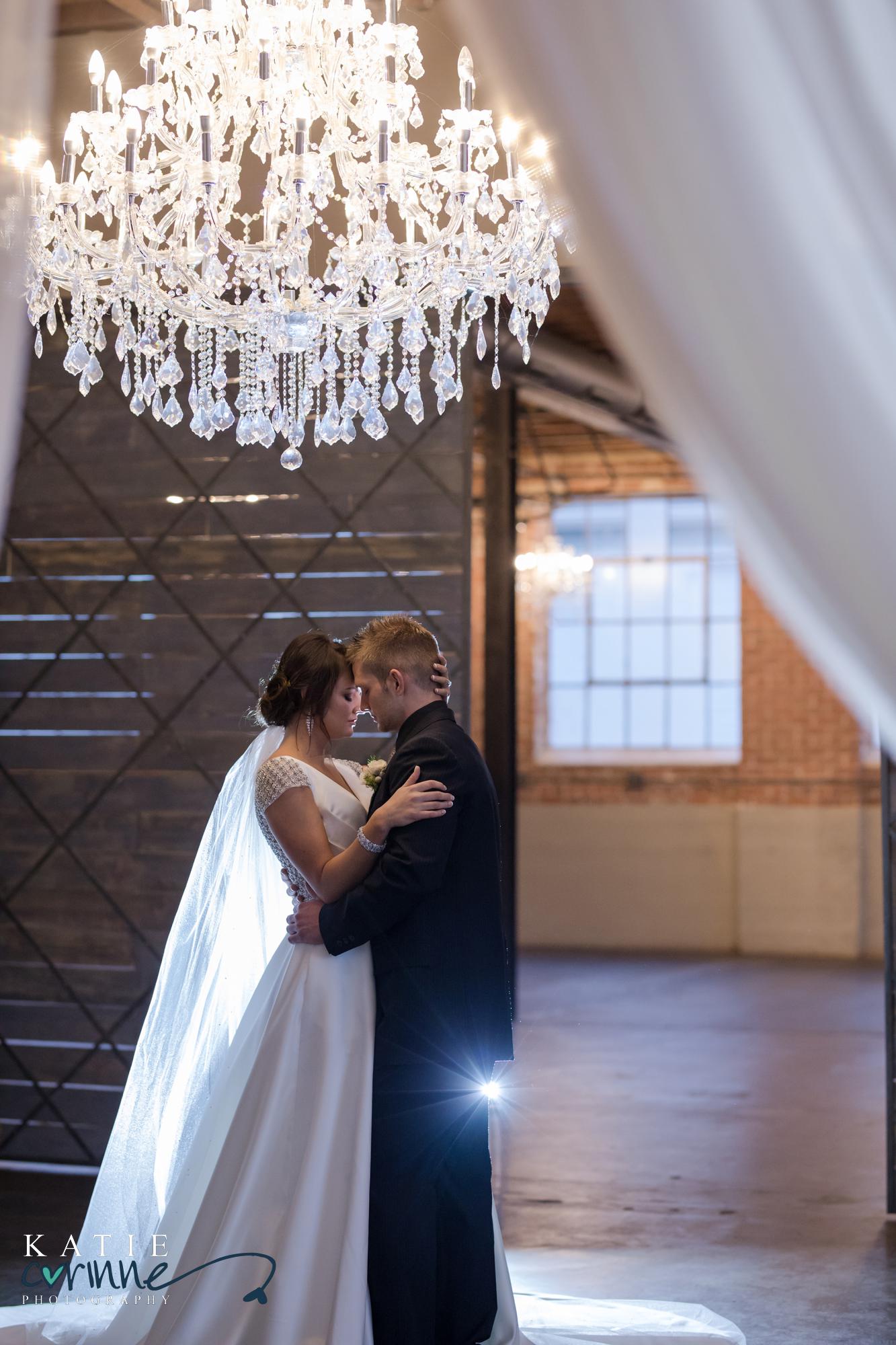 wedding couple face each other while backlit at Moss Denver