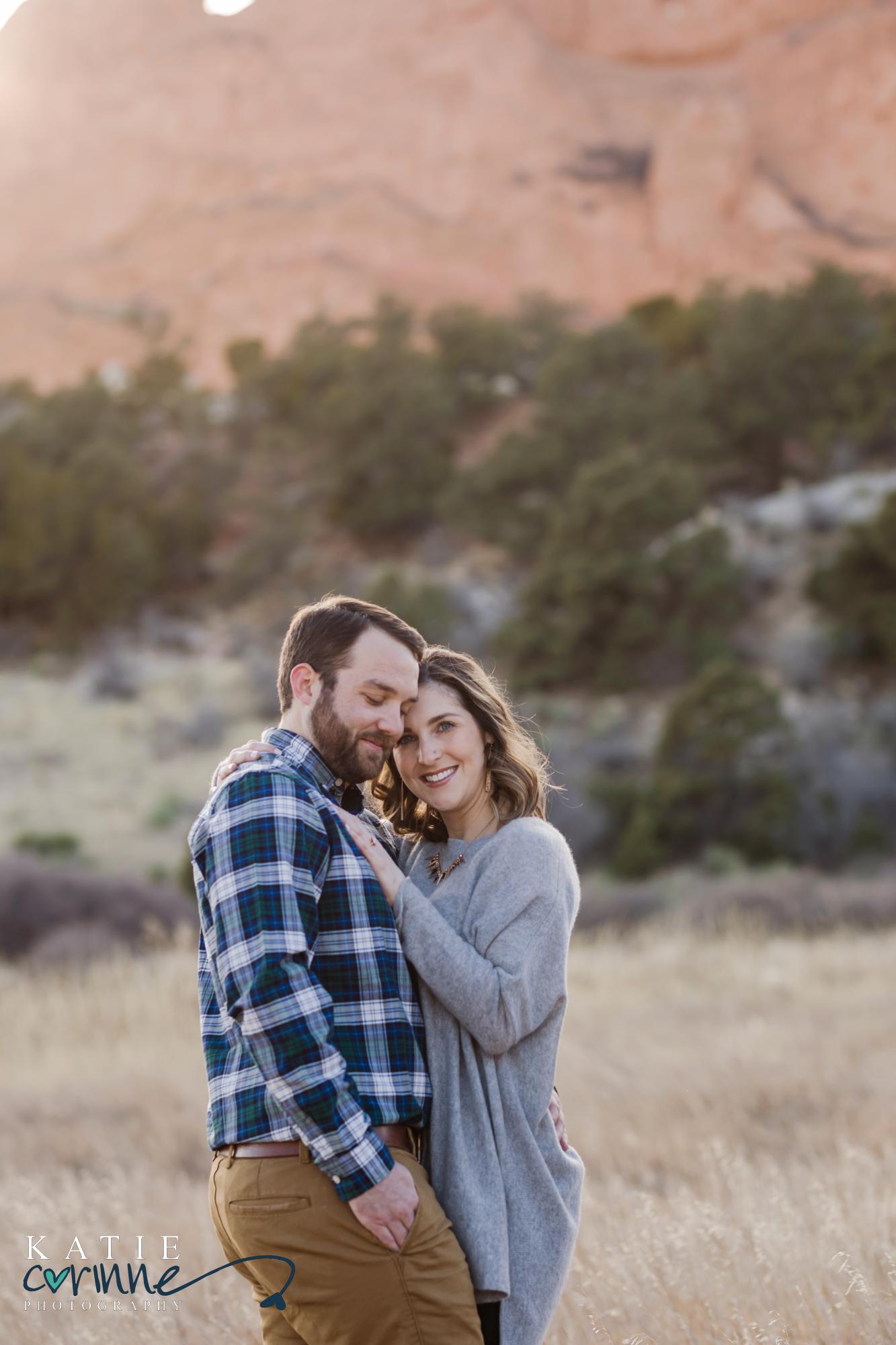 couple poses for photos at their winter engagement