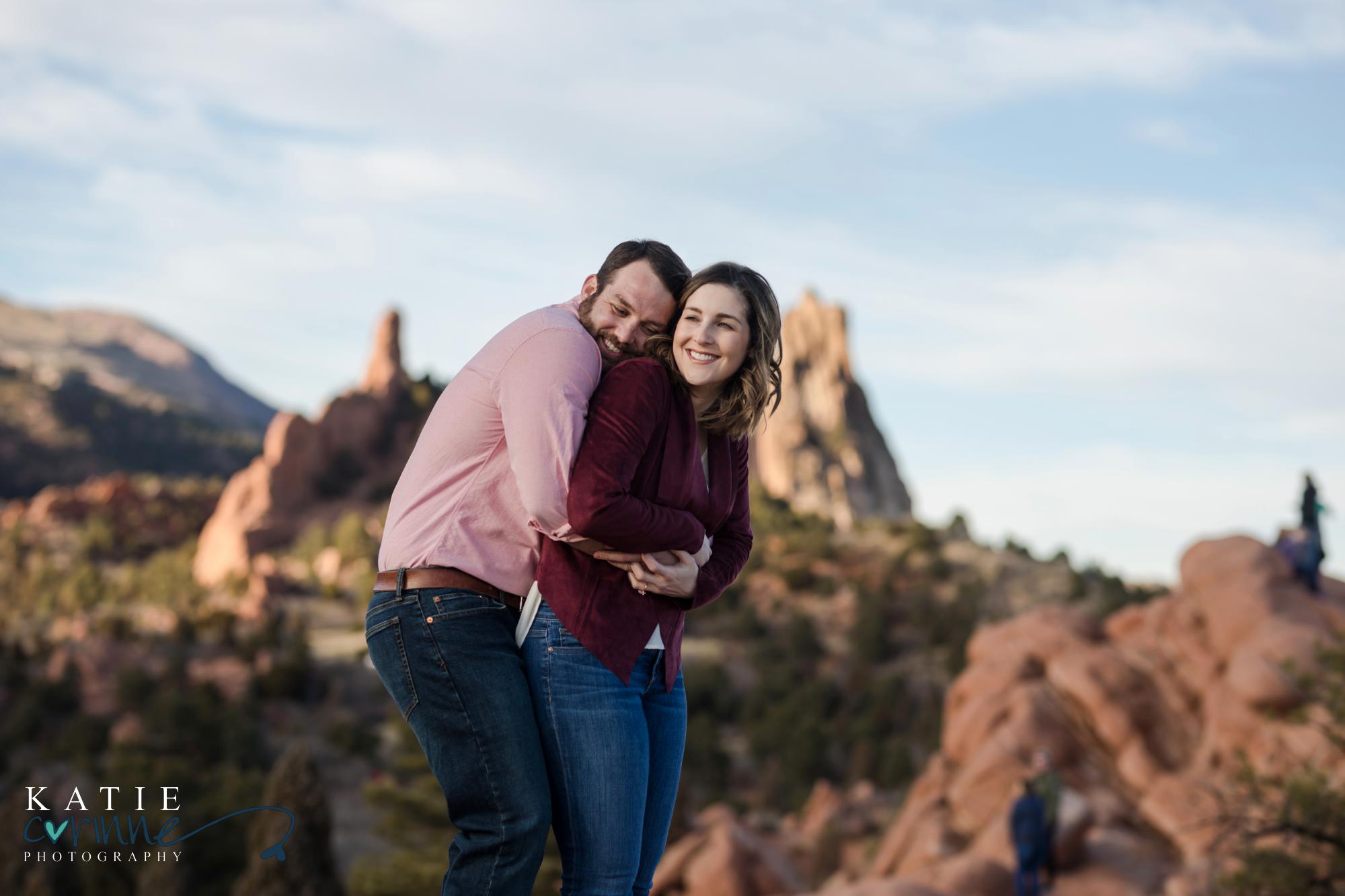 couple holds each other laughing in Colorado Springs park