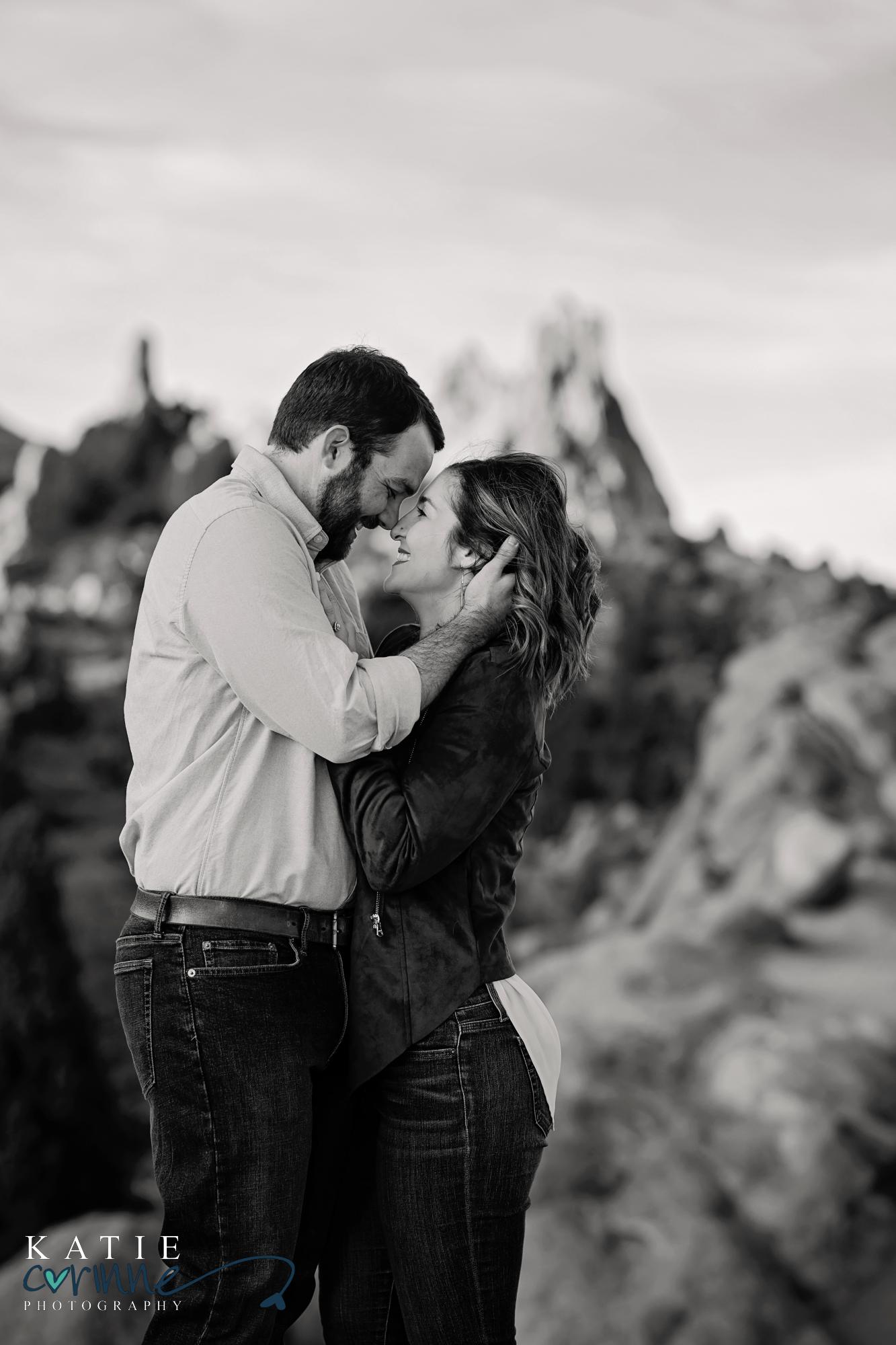 couple looks at each other smiling at winter engagement session