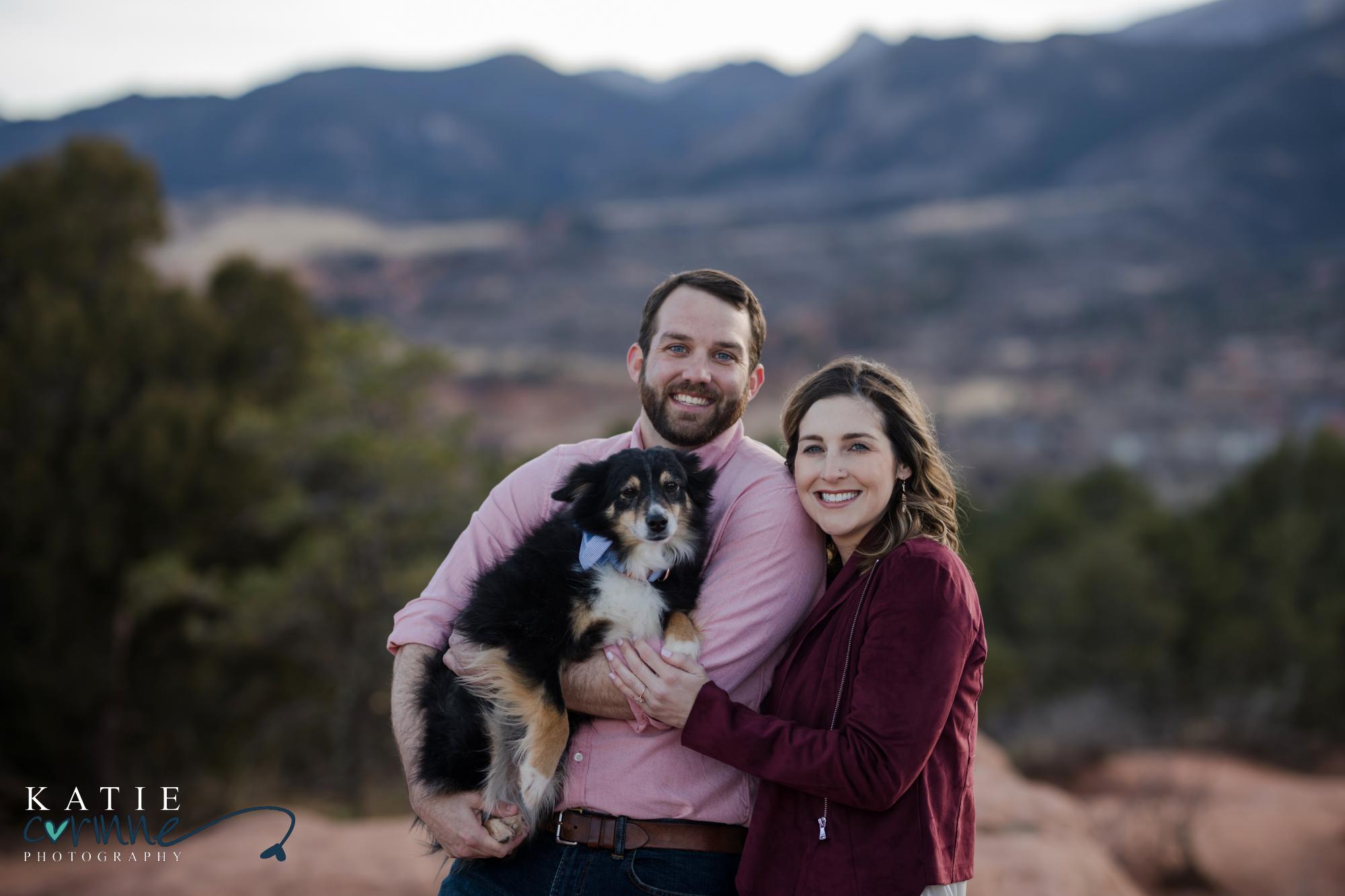 Man holds dog with new fiance and pose for photos