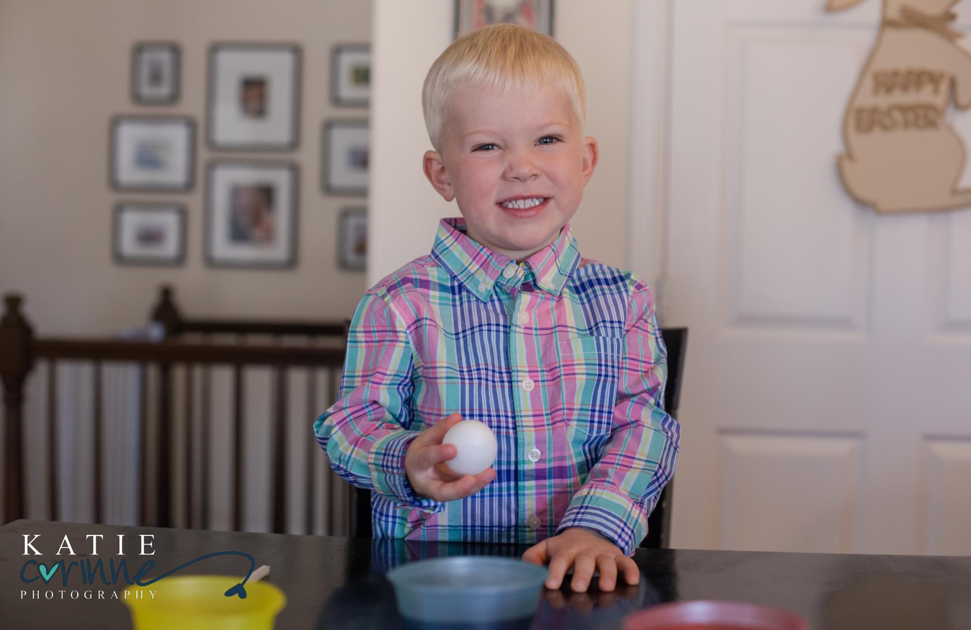 boy holds egg at Easter gender reveal