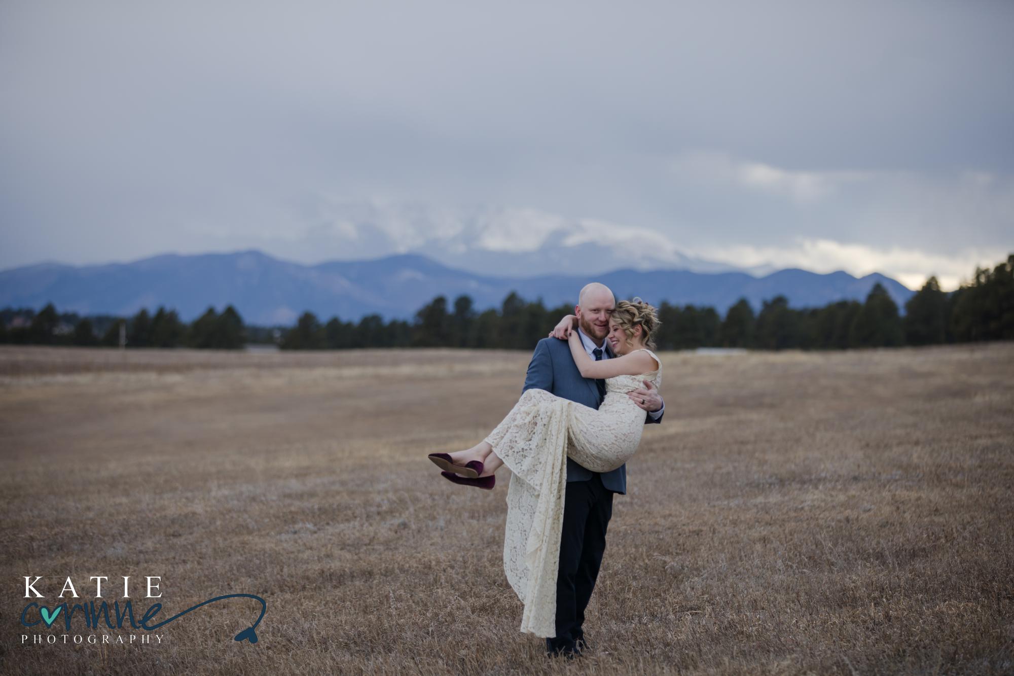 Groom holds bride in his arms at Younger Ranch Wedding