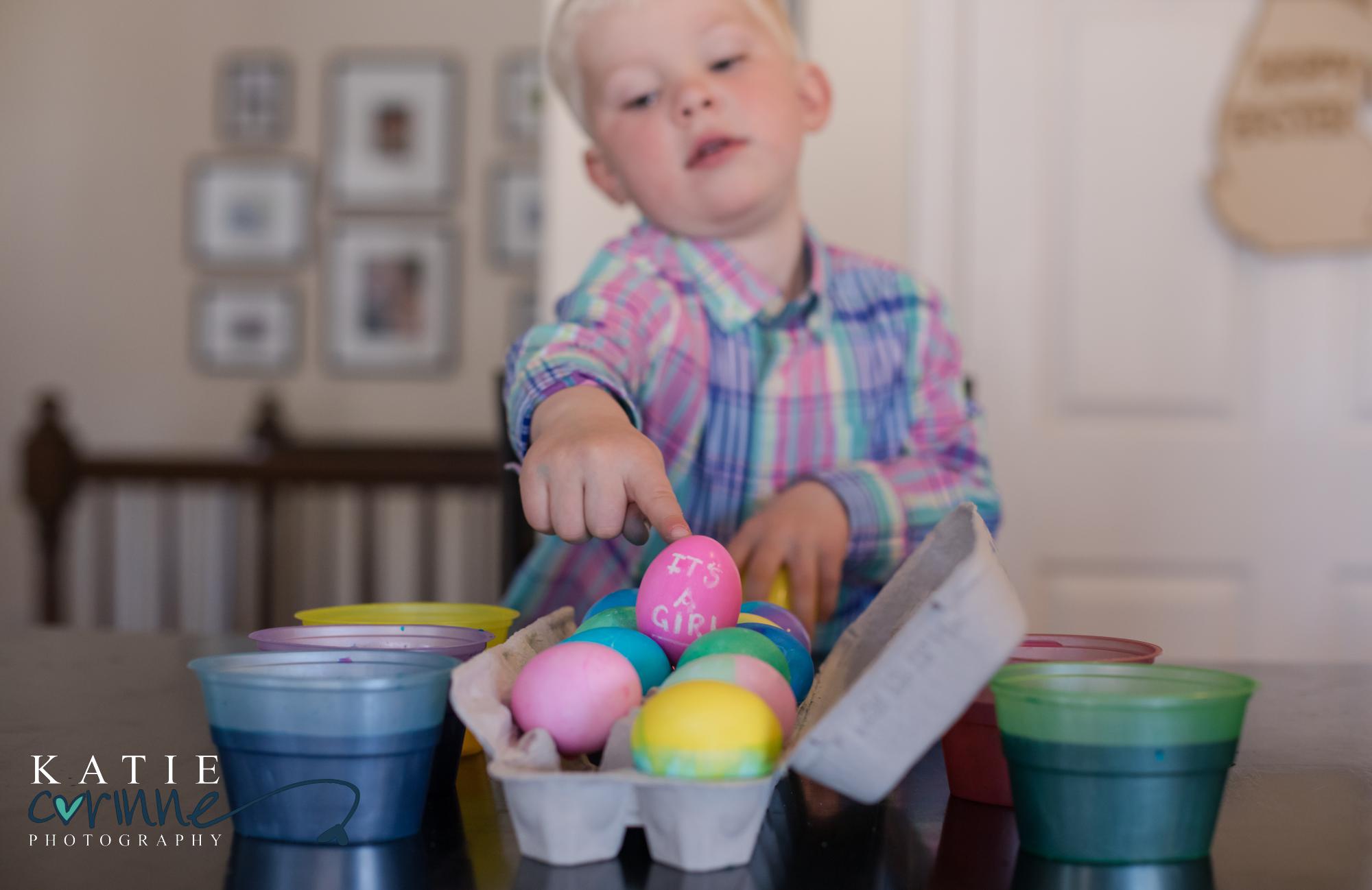 Colorado Springs child points to pink egg showing gender of baby sister