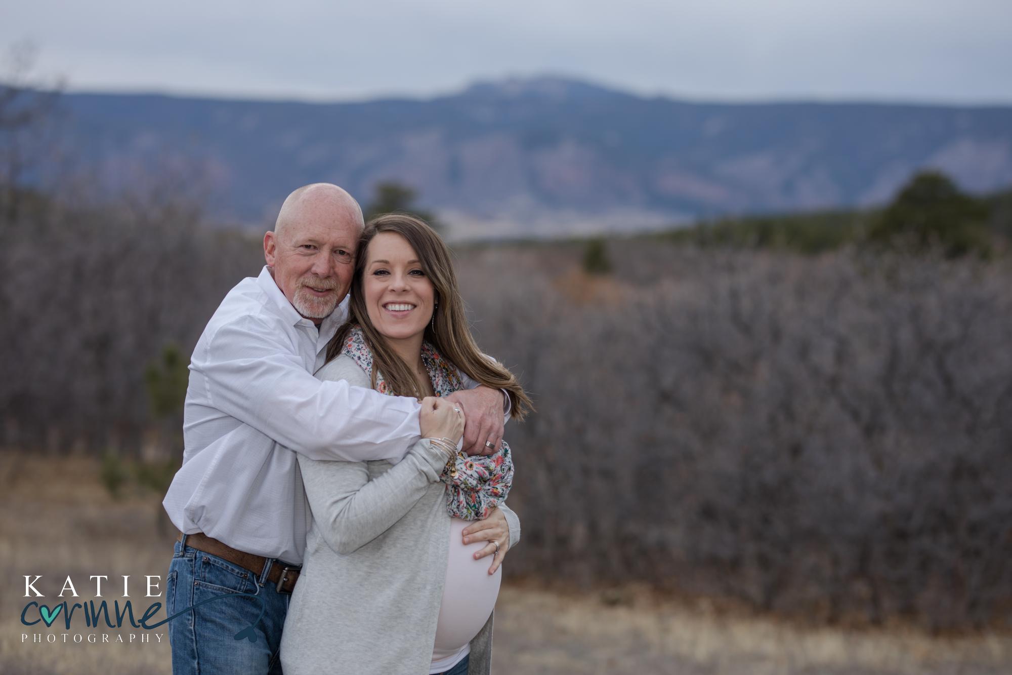 couple holds each other at Colorado maternity sessions