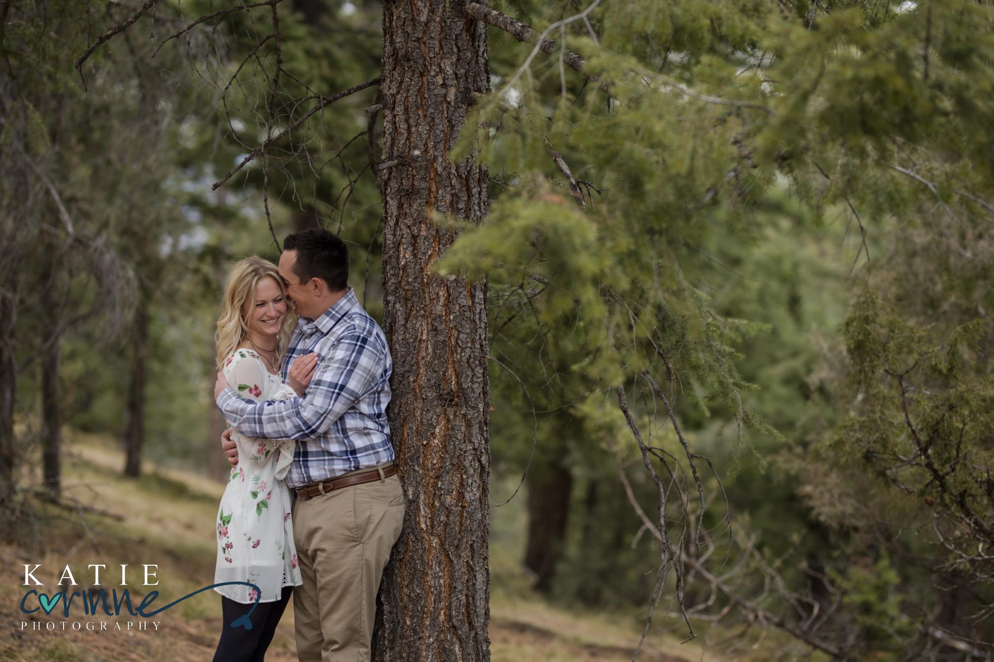 Colorado couple against evergreen tree