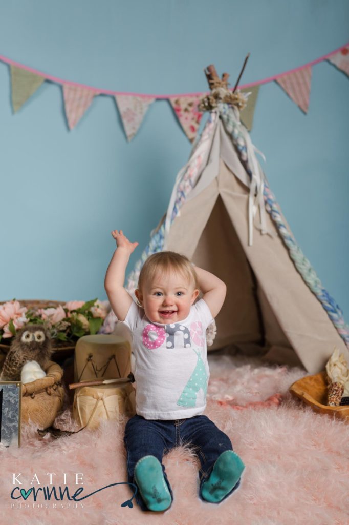 One year old baby in front of teepee in Colorado