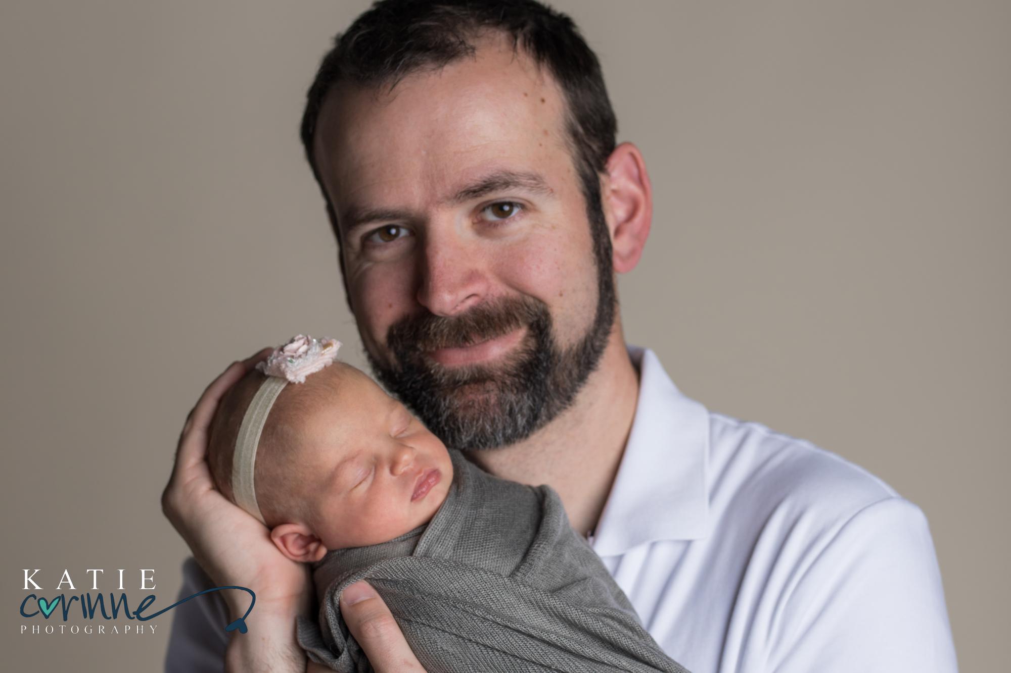 Colorado Springs father holds his newborn daughter