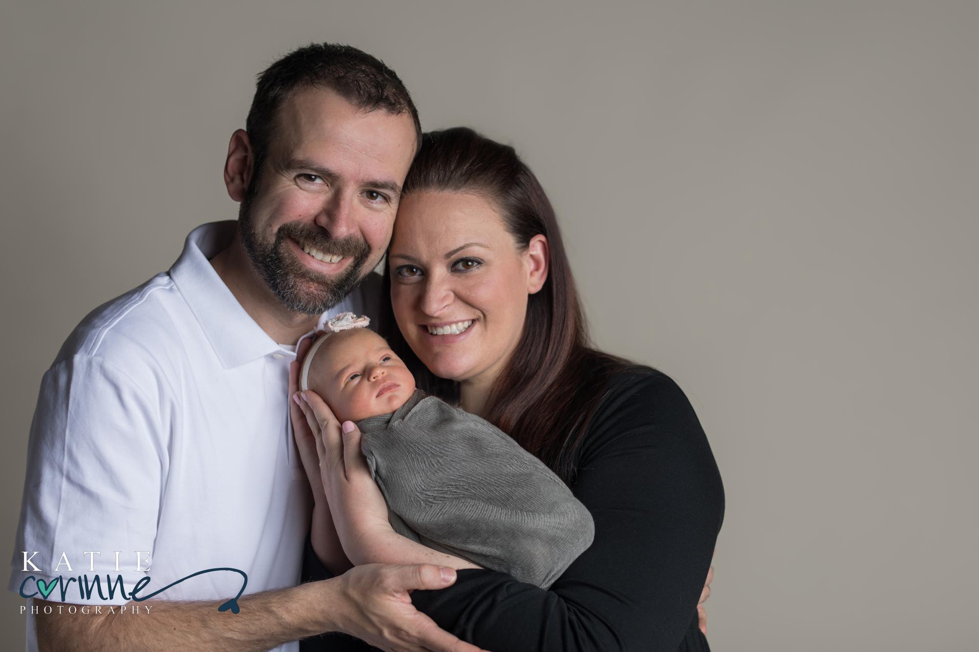 Colorado parents hold baby in newborn photography studio