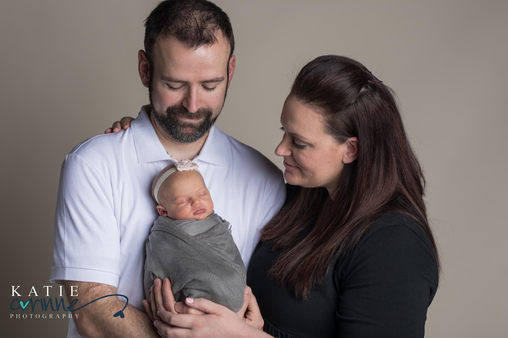 Parents hold baby in Colorado Springs newborn photography studio