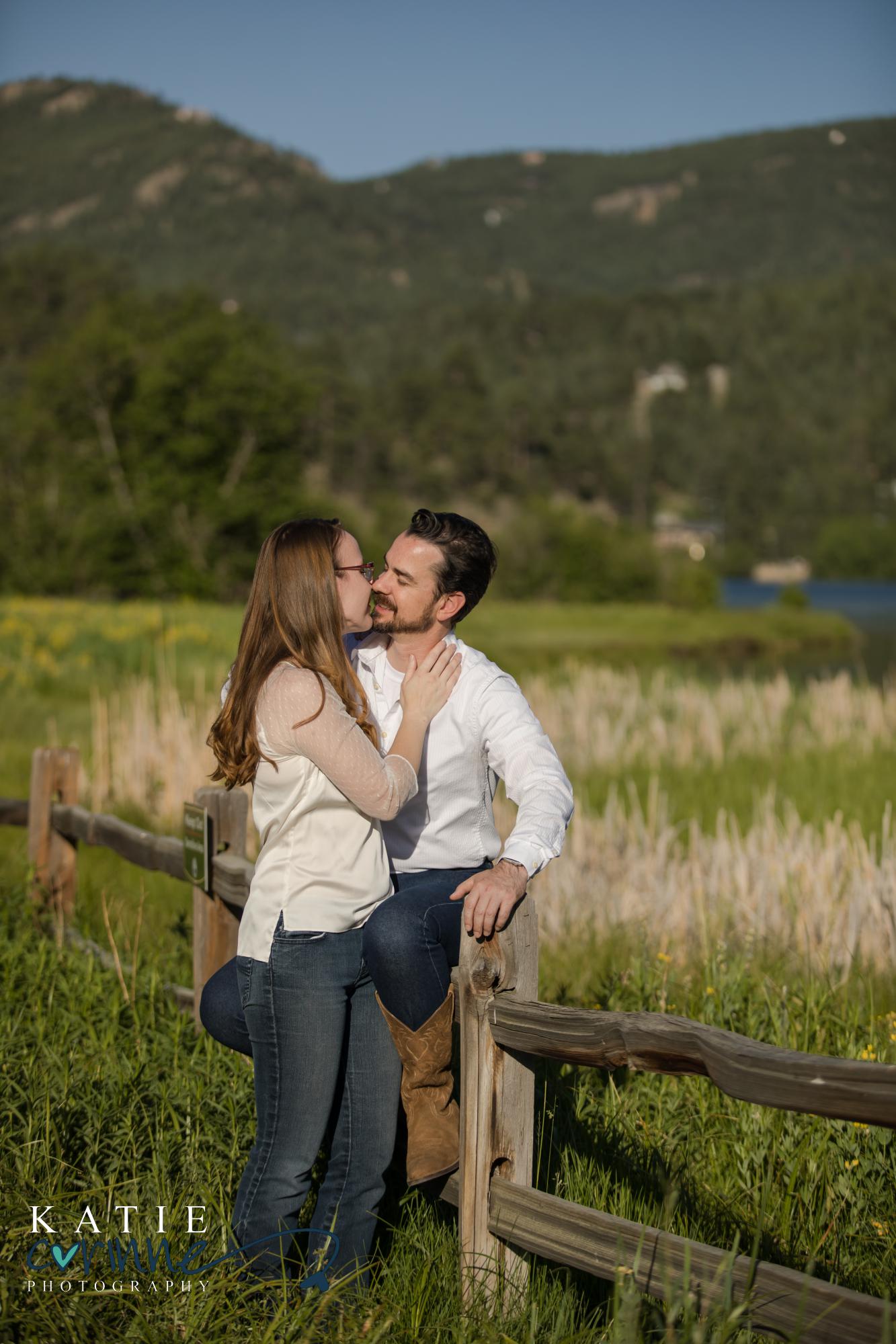 engaged couple on bridge in evergreen, colorado