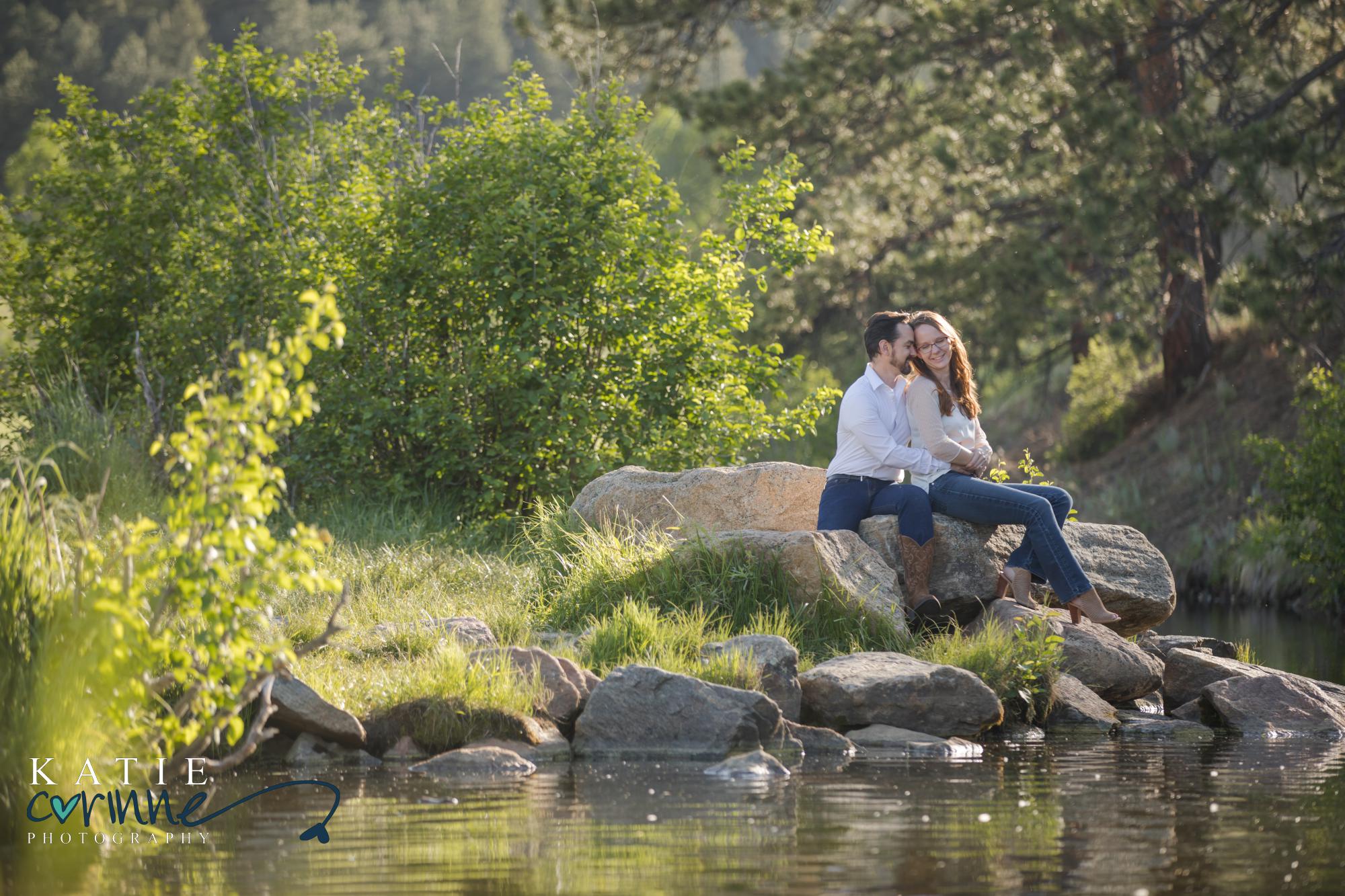 engaged couple by evergreen lake