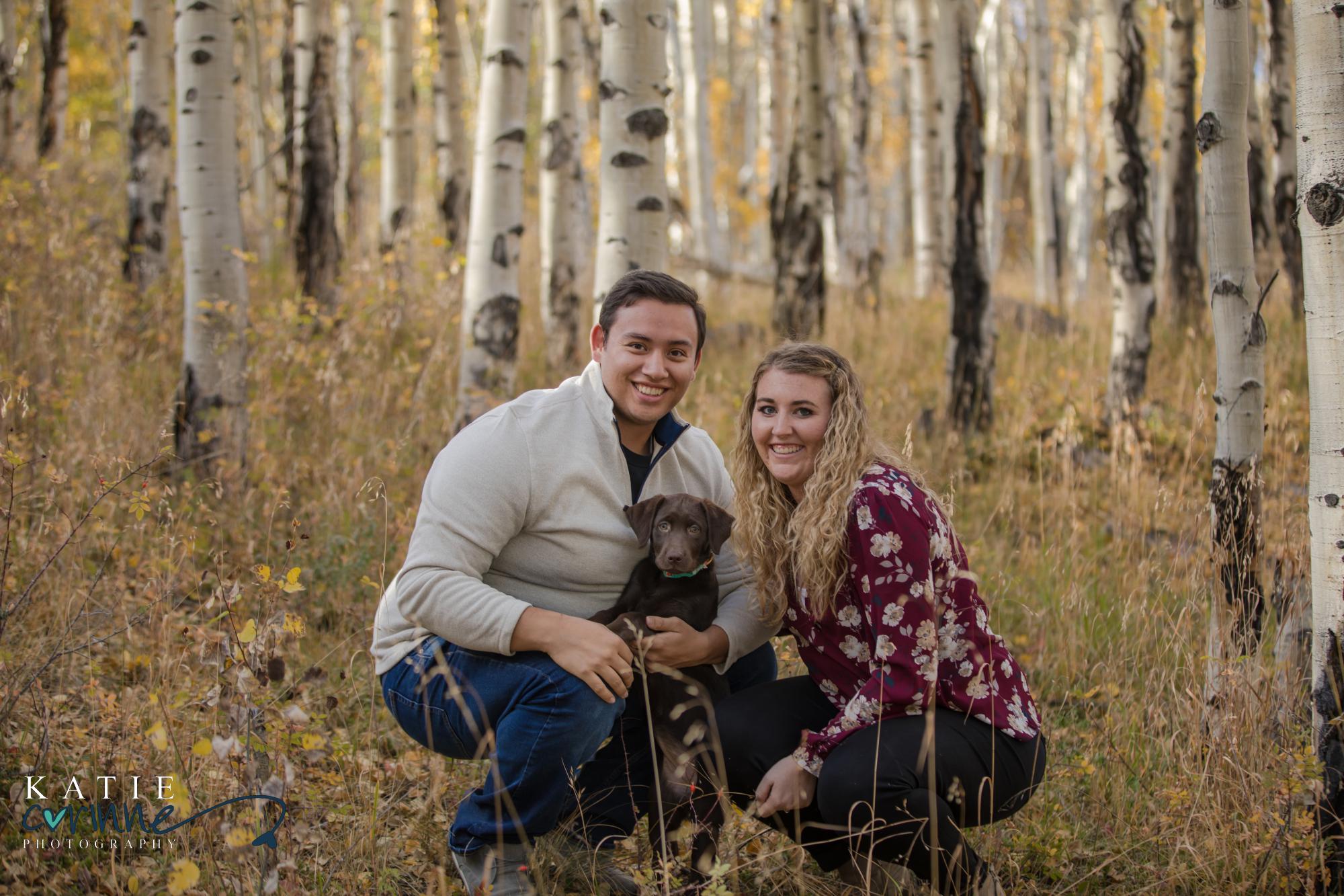Colorado engaged couple pose with their puppy