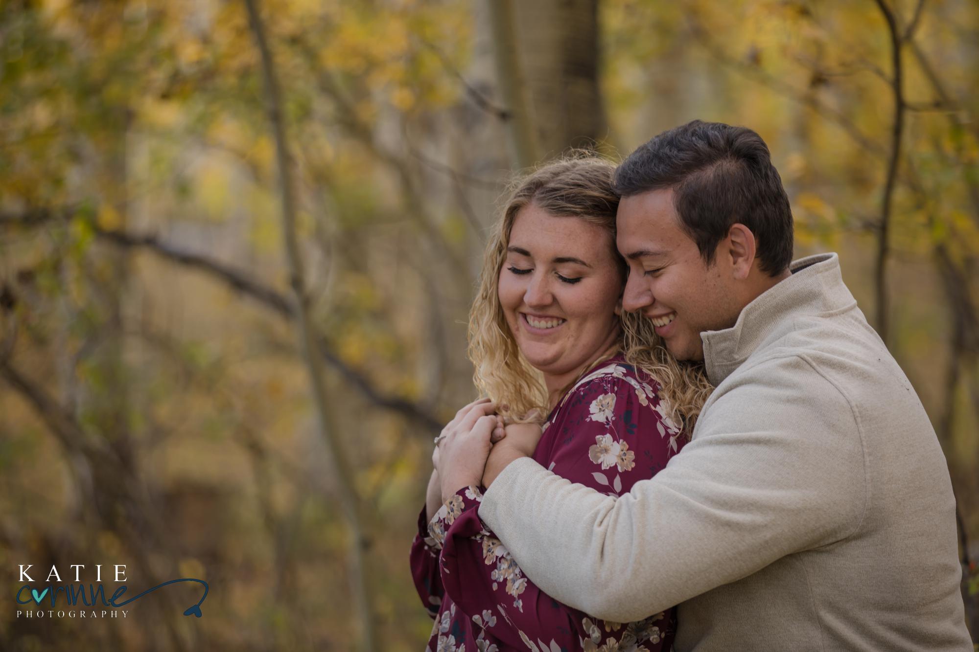 newly engaged couple among fall leaves