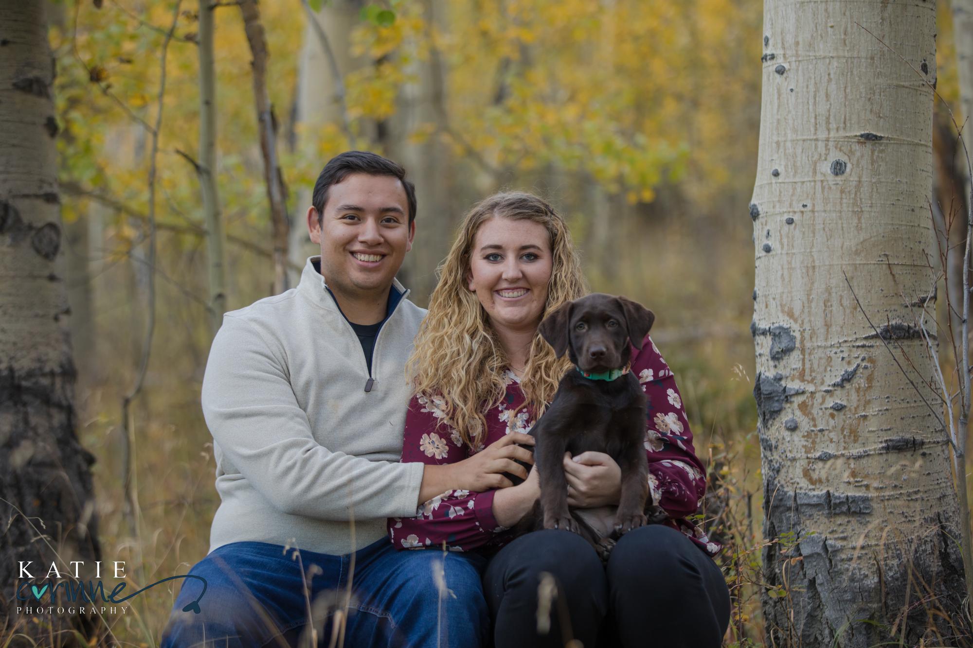 engaged couple with dog in Colorado